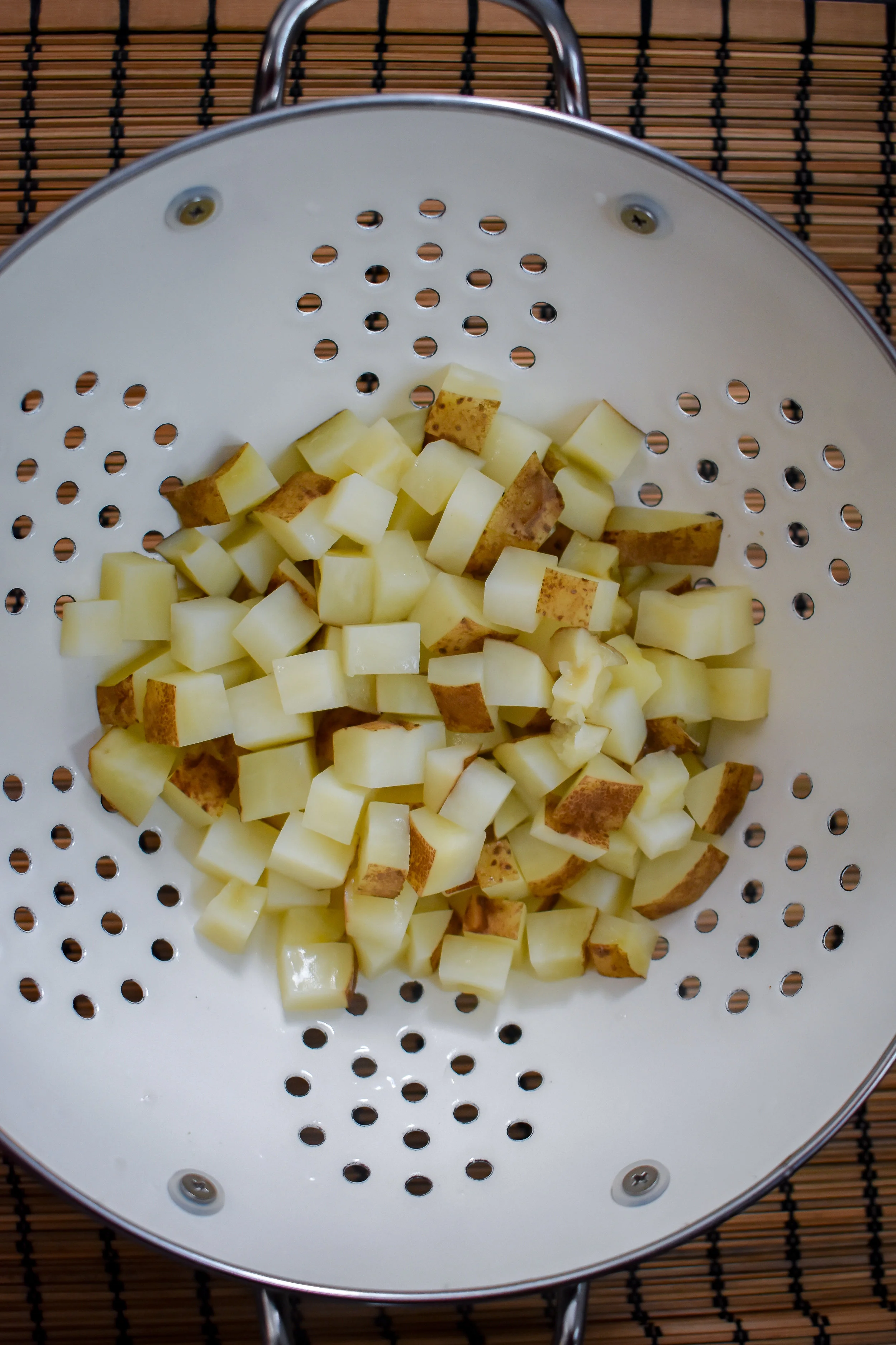 1. To start, add potatoes to a large microwave-safe bowl with 2 tbl of water. Microwave for 6 minutes to parboil potatoes.