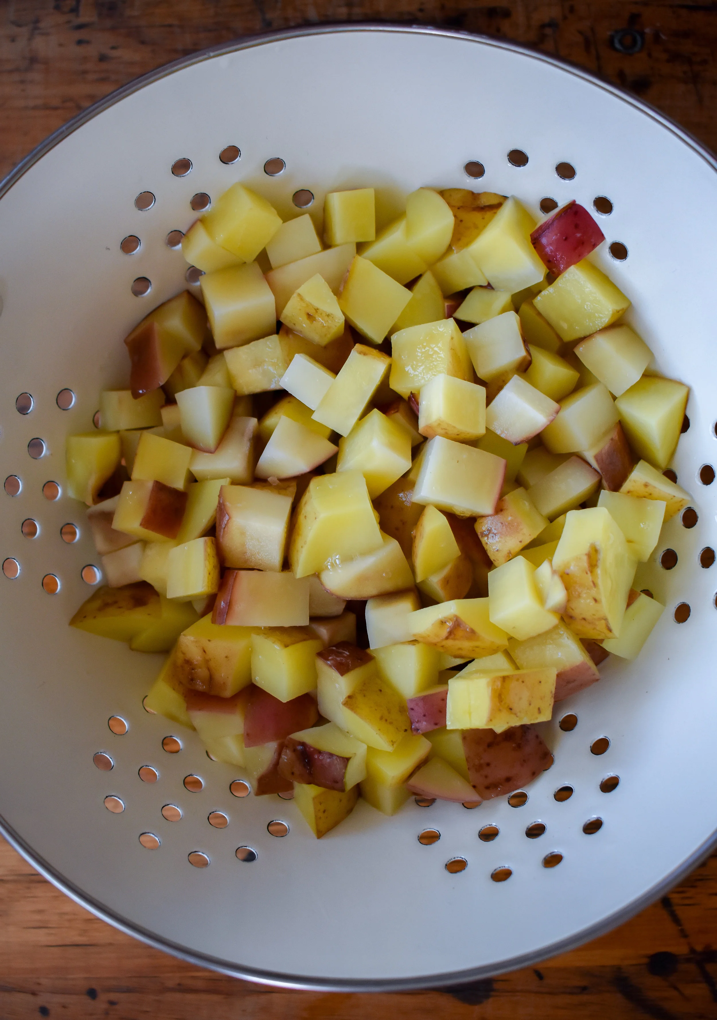 1. To start, add potatoes to a large microwave-safe bowl with 2 tbl of water. Microwave for 7-8 minutes to parboil potatoes.