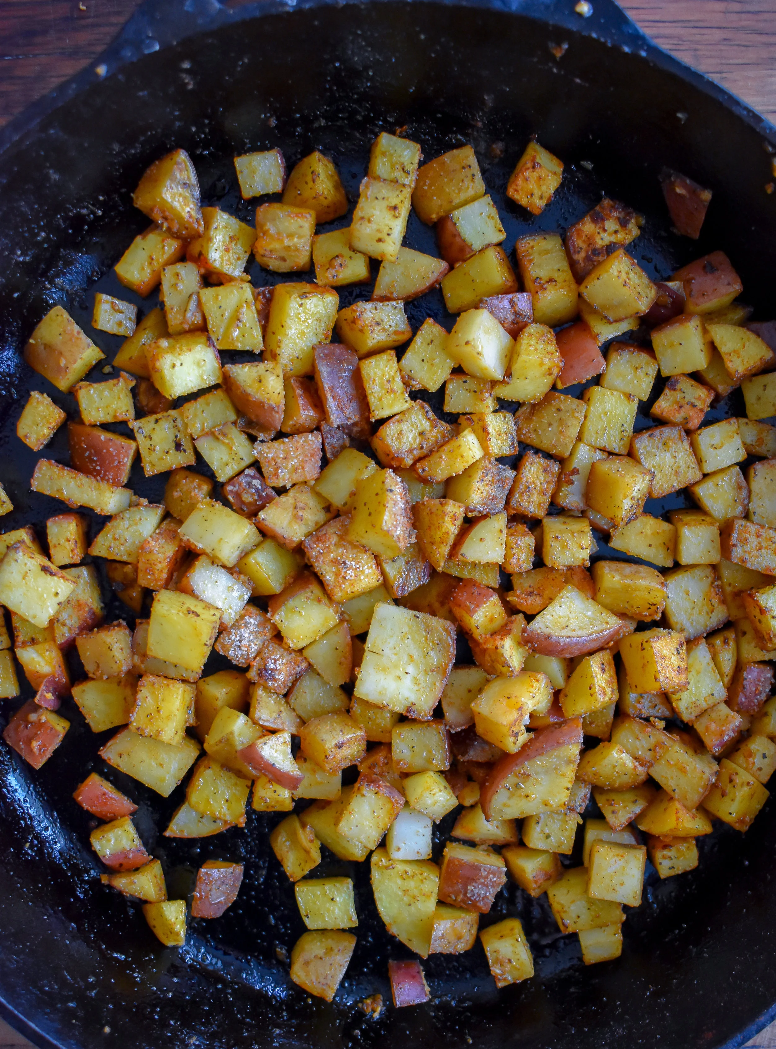 3. Add potatoes to a castiron pan with vegan butter + spices and cook over medium heat for 7-8 minutes until a nice sear forms. Set aside.
