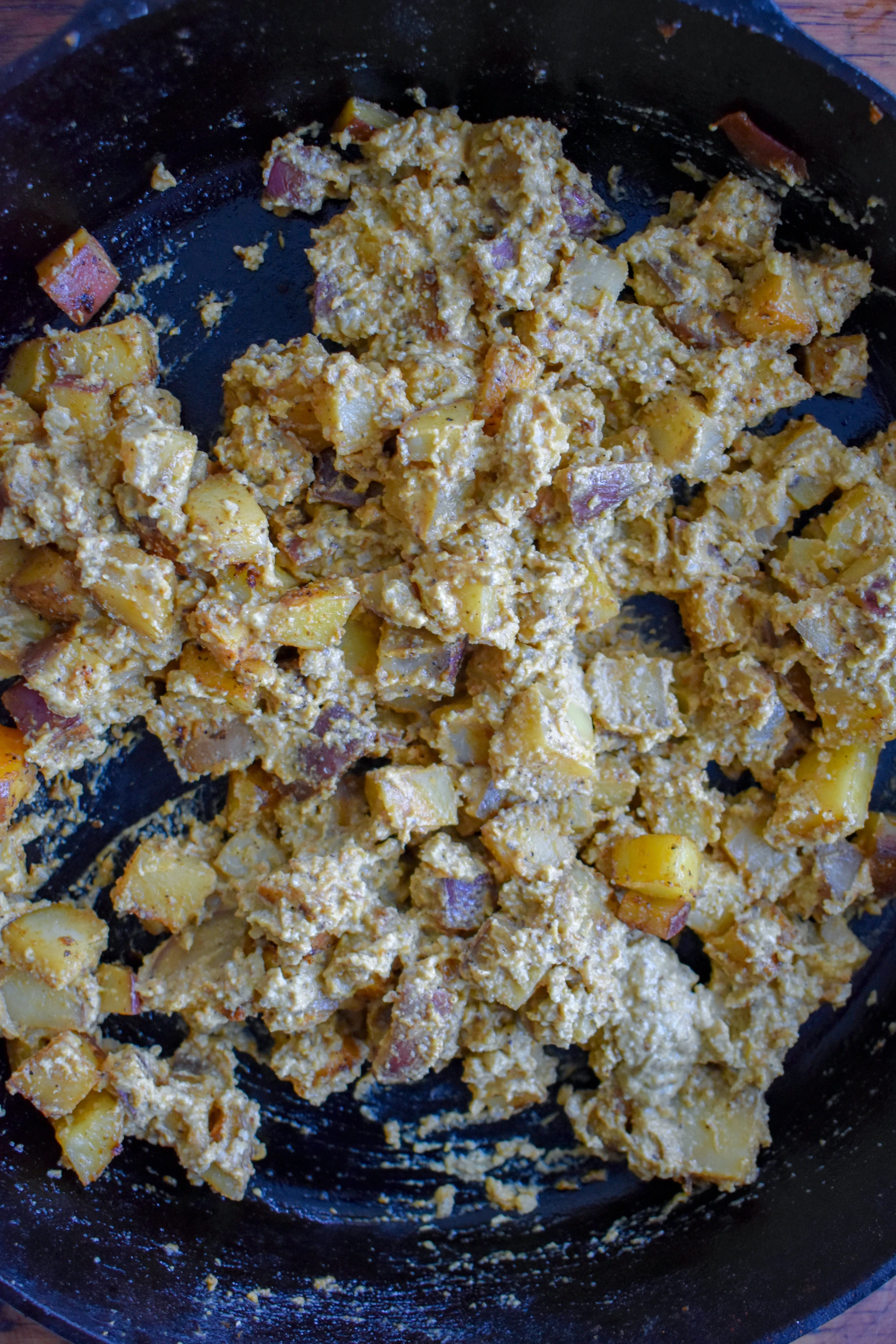6. Once the potatoes are done and have cooled for a few minutes, mix in the cheese sauce mixture. Set aside.