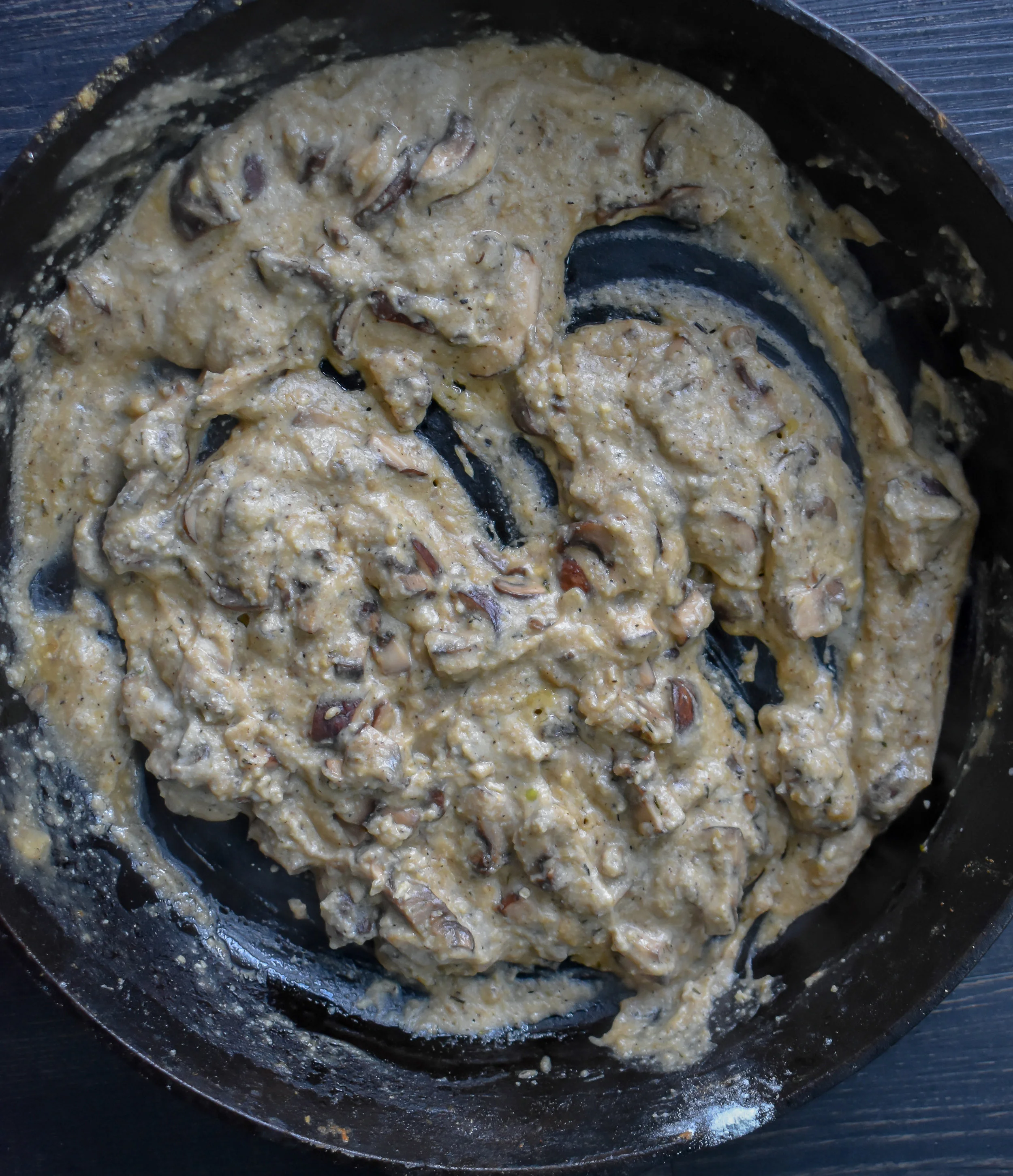 5. Melt vegan butter in a cast iron pan at medium heat. When the butter starts to pop, add in the mushrooms with a pinch of salt + pepper. Cook for 4-5 minutes. Next, add in the garlic + spices. Cook for 2 more minutes before adding the flour. Cook another 60 seconds and add broth. Cook for another 5-6 minutes before pouring in the cashew cream. Mix it well. Take off heat.