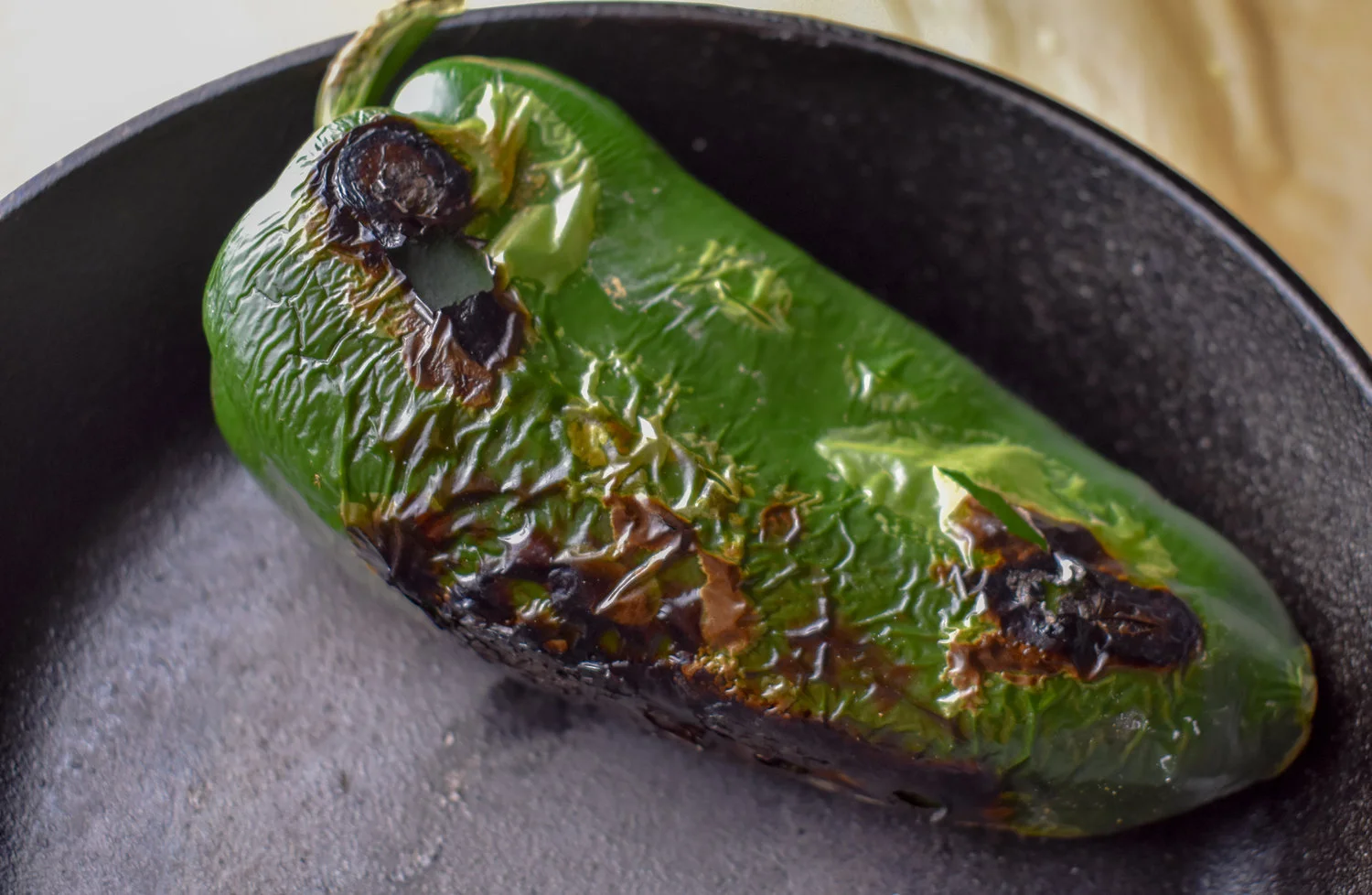 6. While the falafel are browning, add a full poblano to a dry pan (I prefer castiron). Turn it on medium heat and let the poblano char on each side for 2-3 minutes. You want it to be pretty blackened on each side.
