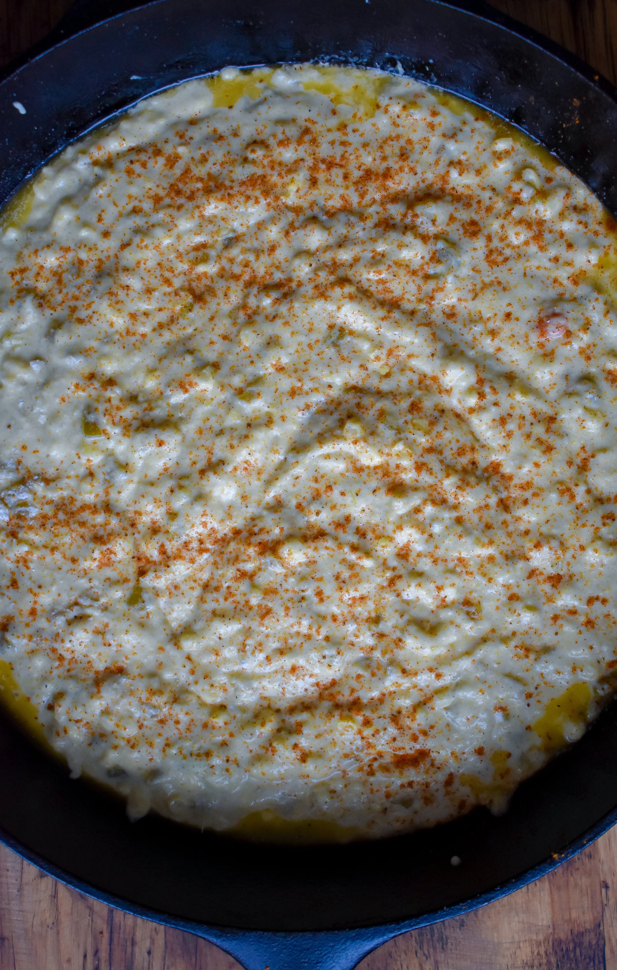5. Using some neutral oil or butter, rub down the castiron pan. Pour in the batter and sprinkle on smoked paprika, creole seasoning, and salt. Bake at 400F for 30-35 minutes until a fork comes out clean from center and edges are crispy,