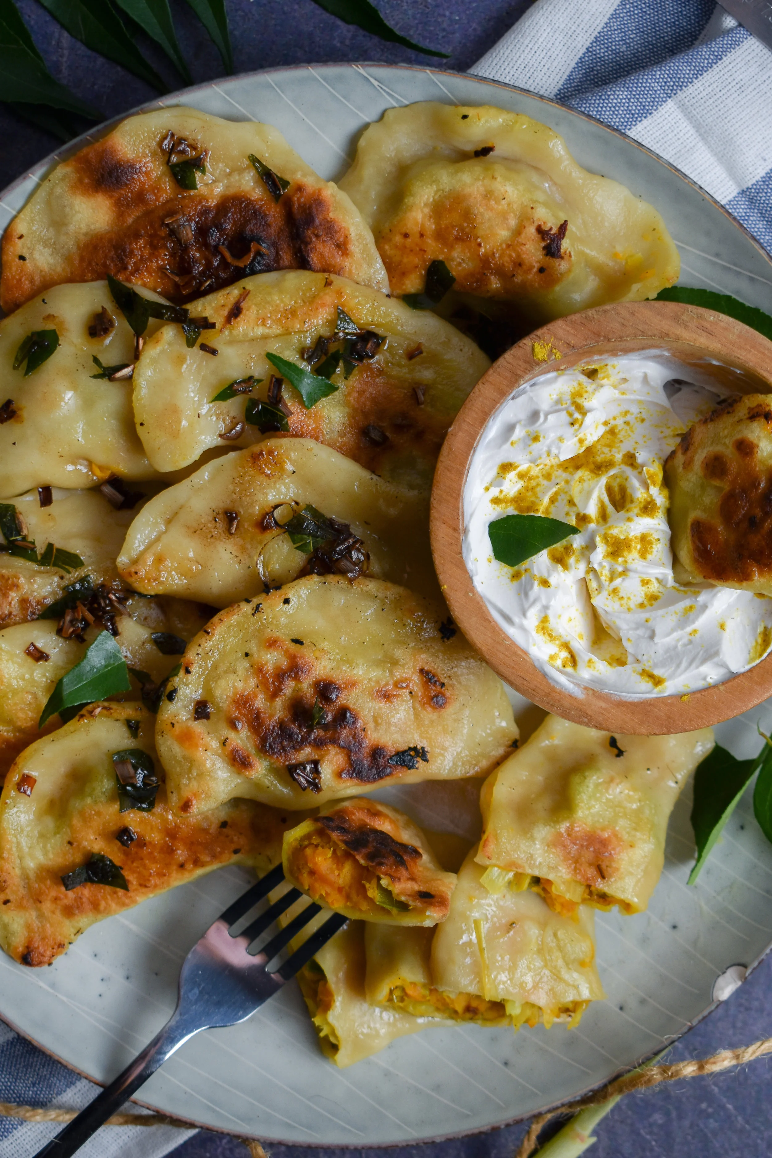 11. For the brown butter, add butter to a pan and cook for 7-8 minutes over medium-high heat then add in lemongrass + curry leaves + garlic in last couple minutes. Pour over top. Serve with sour cream and dig in! Enjoy!