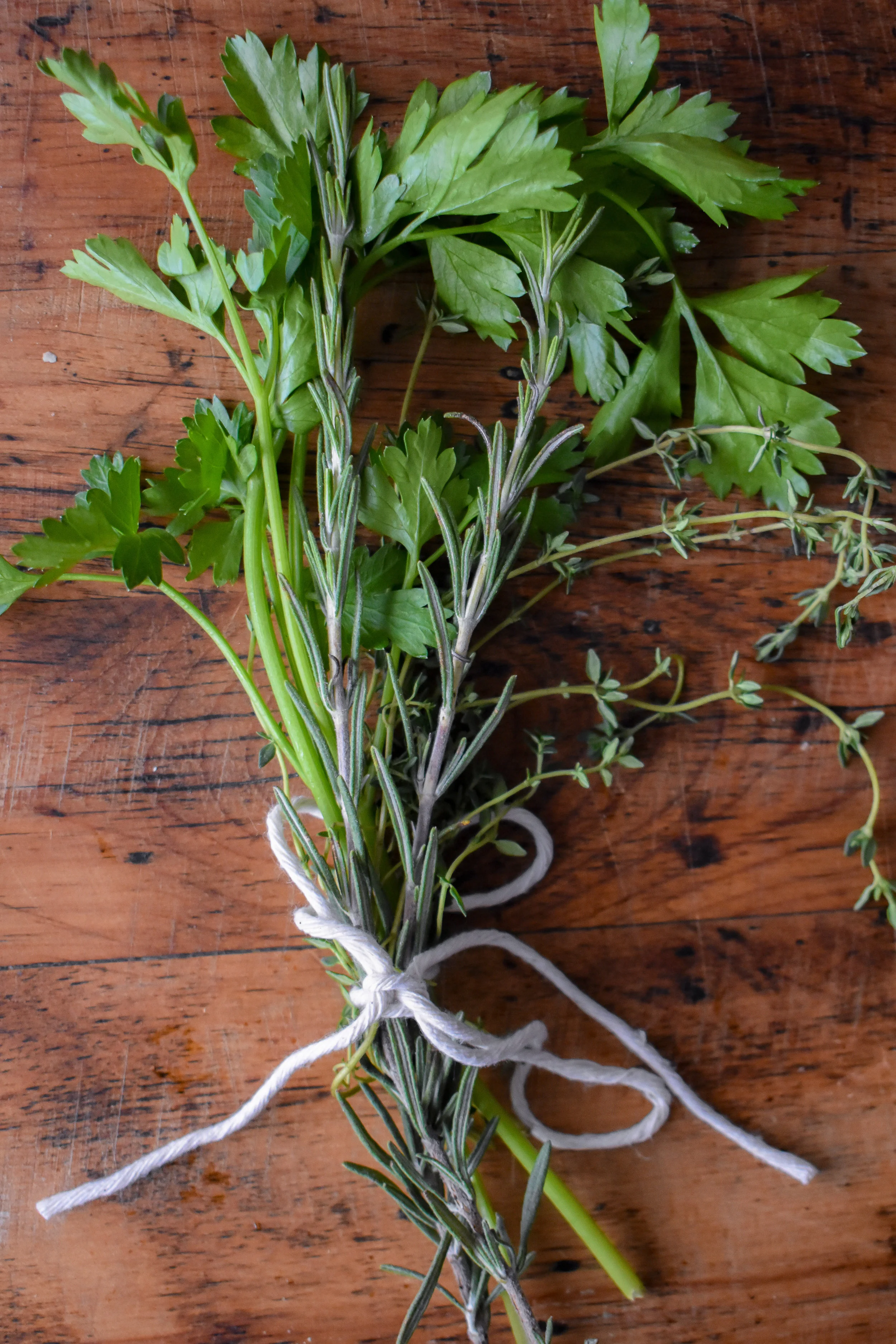 5. While the onions cook, use kitchen twine/string to tie together the fresh herbs for the jam. If you don’t have kitchen twine, you can put the herbs in without the twine. You’ll need to pick it out later, so be careful.