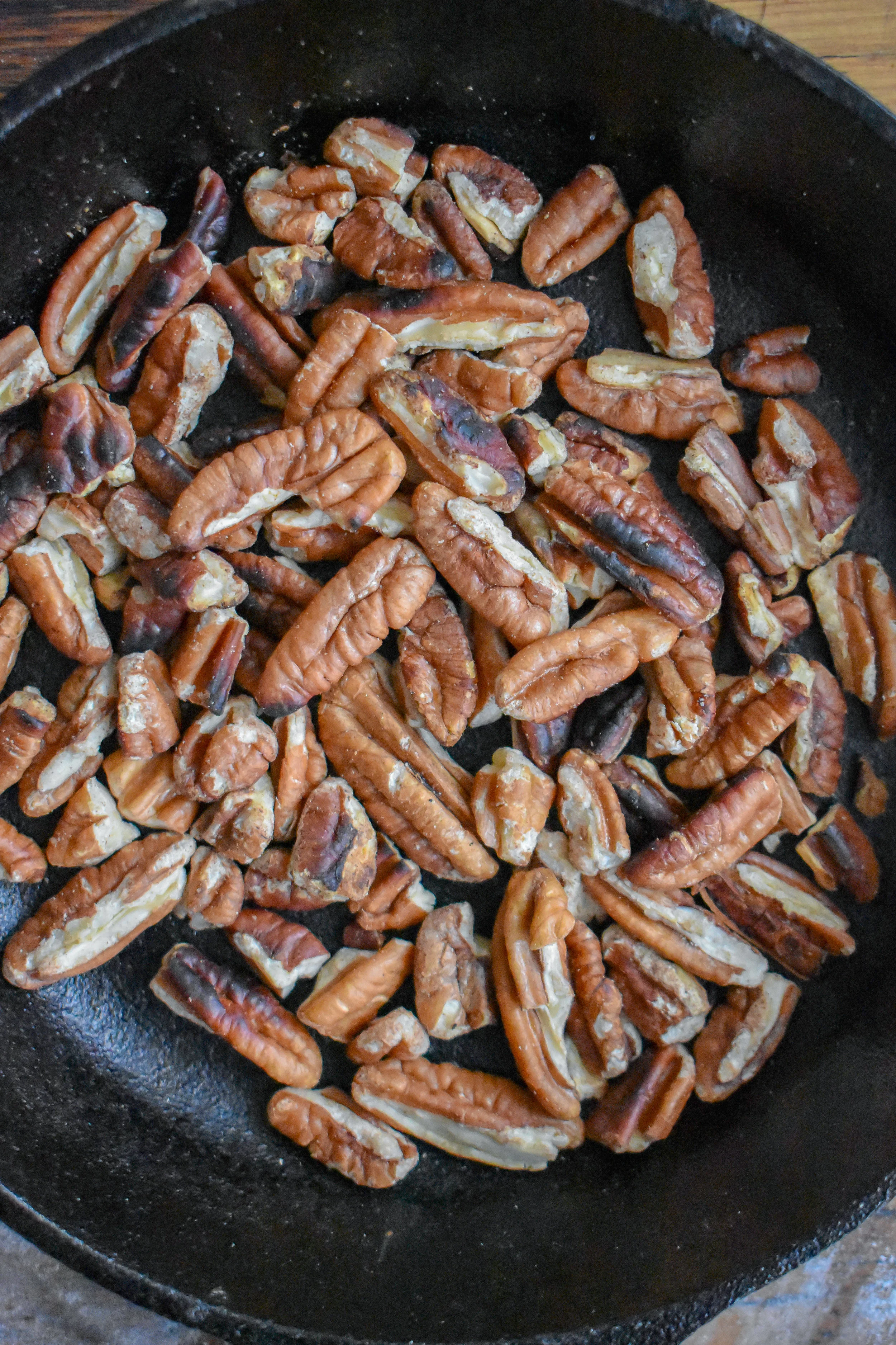 7. While the onion jam cooks, add pecans to a dry castiron pan and dry cook for 5-6 minutes stirring once or twice until the pecans start to brown and become fragrant. Take off heat once browned and set aside.
