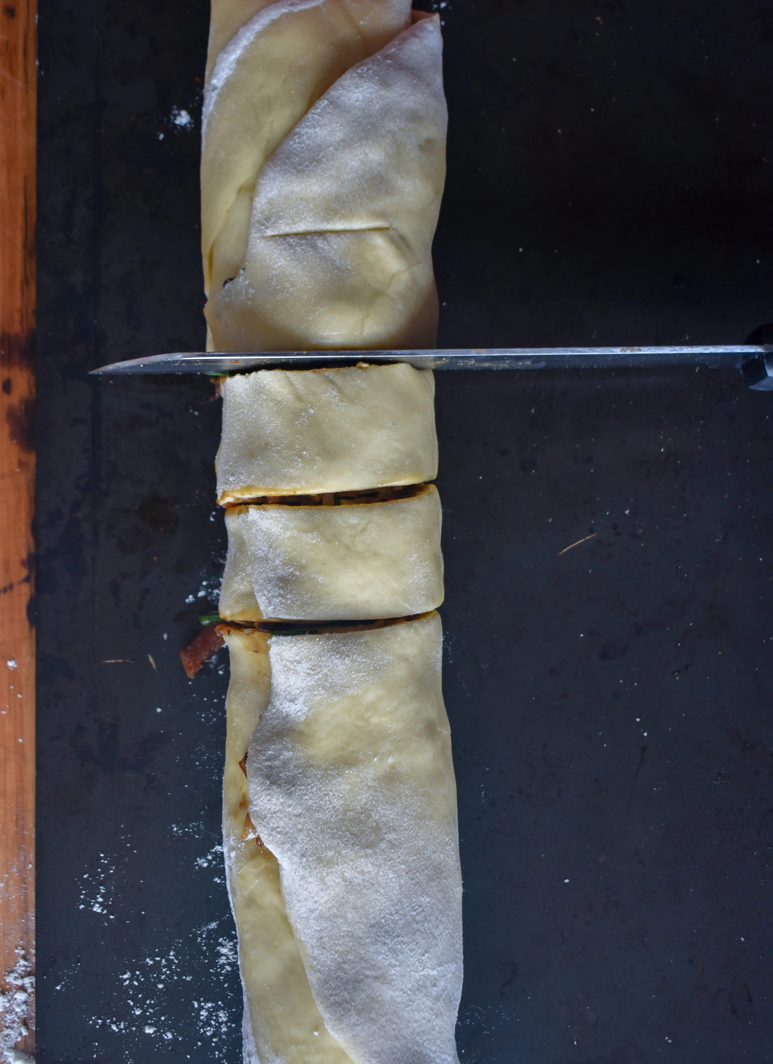 12. After pulling from the freezer, cut into 1-1.5 inch segments. I prefer a bread or serrated knife that saws rather than pushes down. You want the dough’s integrity to stay firm. If you are cutting down and the edges are dropping in, you’ll want to freeze longer or switch knives.