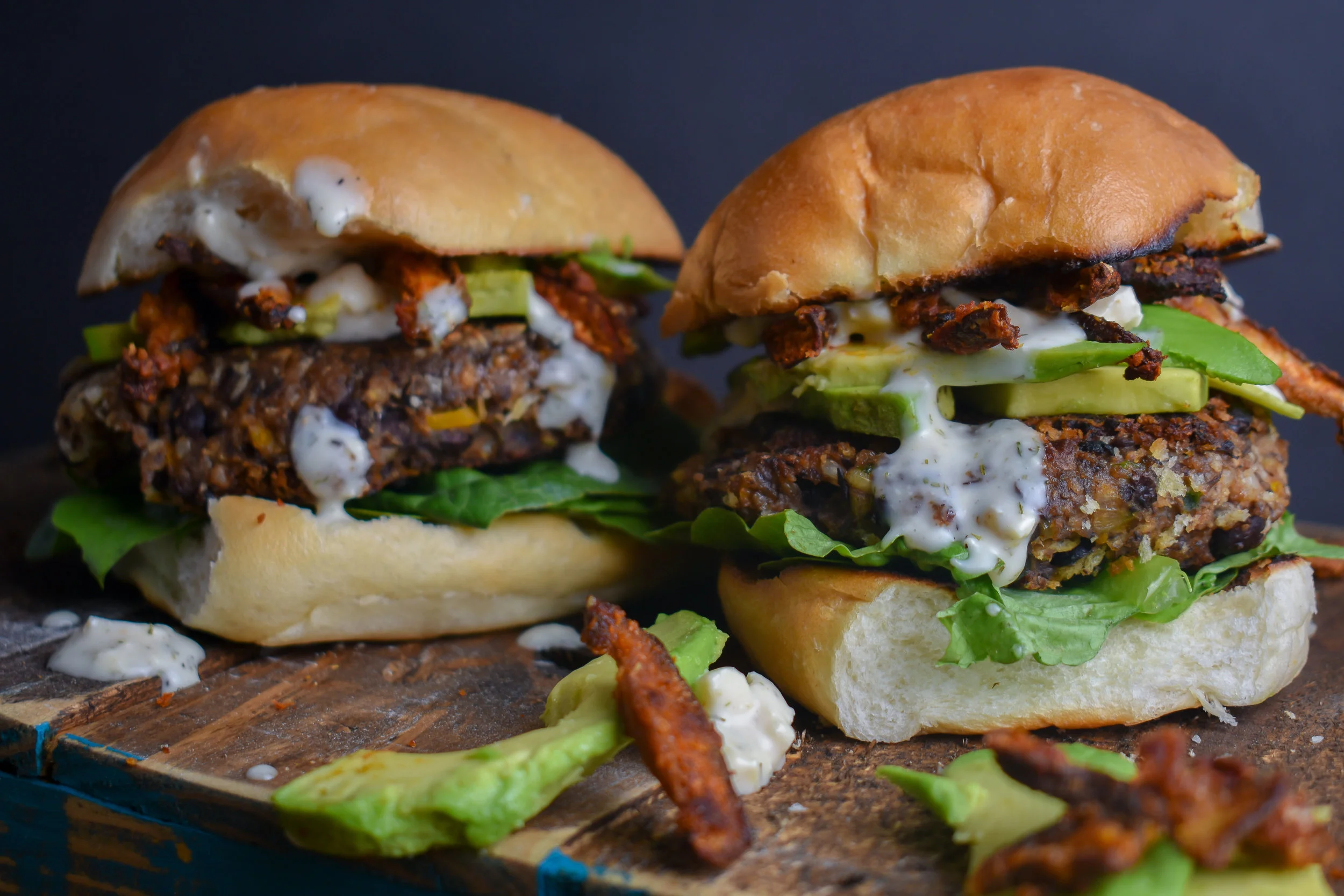 9. To put it all together, serve a toasted bun, with a layer of romaine, then the patty, add avocado slices, pour on the blue cheese sauce, and top with shiitake bacon. Serve!