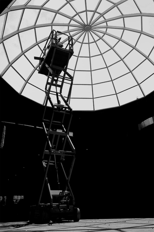 Lift platform inside a domed glass roof structure.