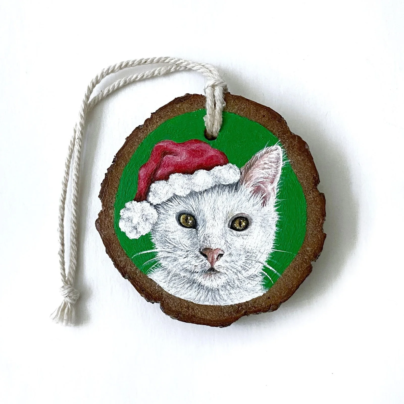 Custom acrylic cat portrait of a white cat in a Santa hat on wood ornament by Emma Sage Fine Art, Los Angeles.