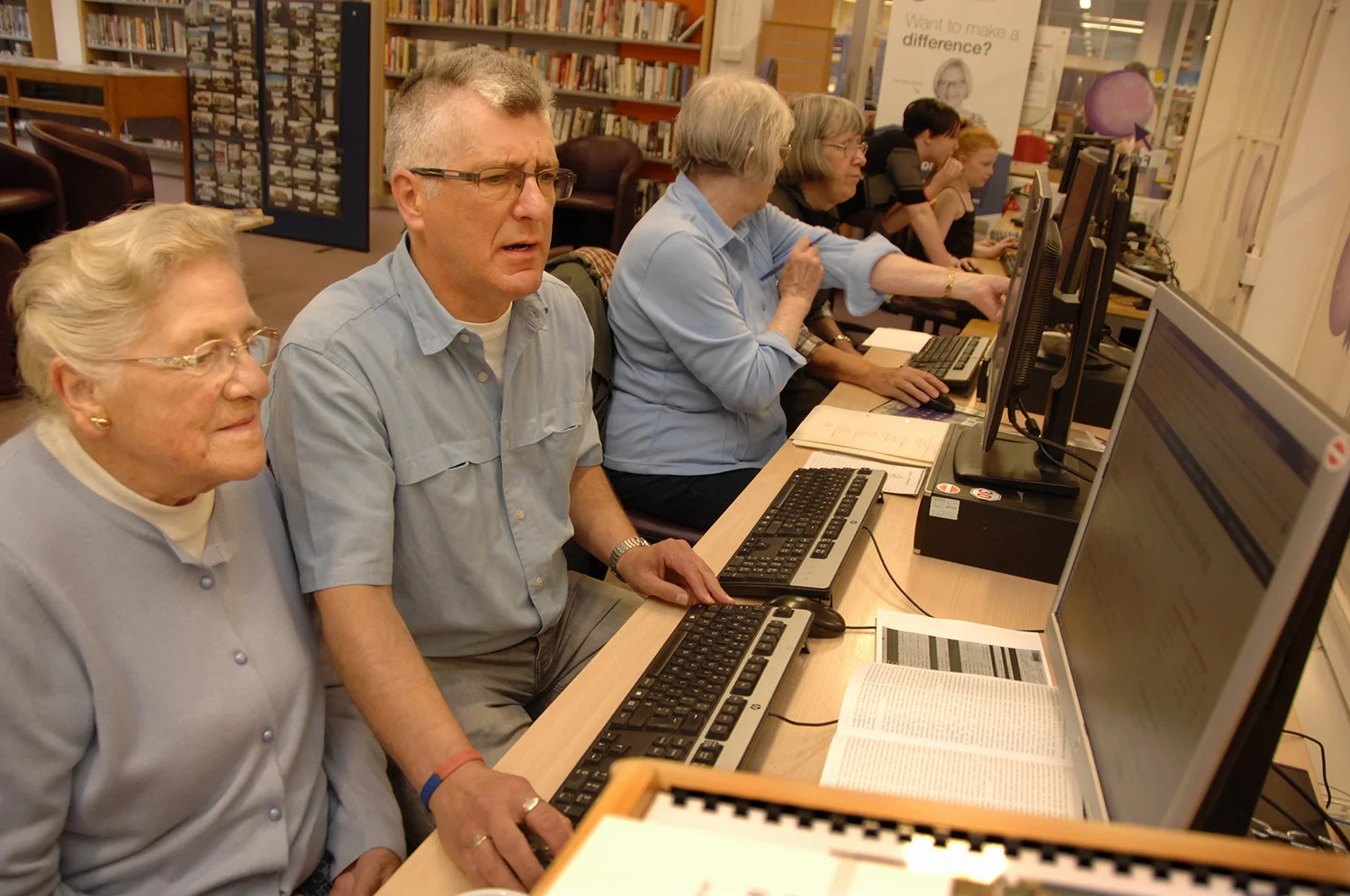 Volunteer Richard Crocker helps Valerie Barron research her family tree