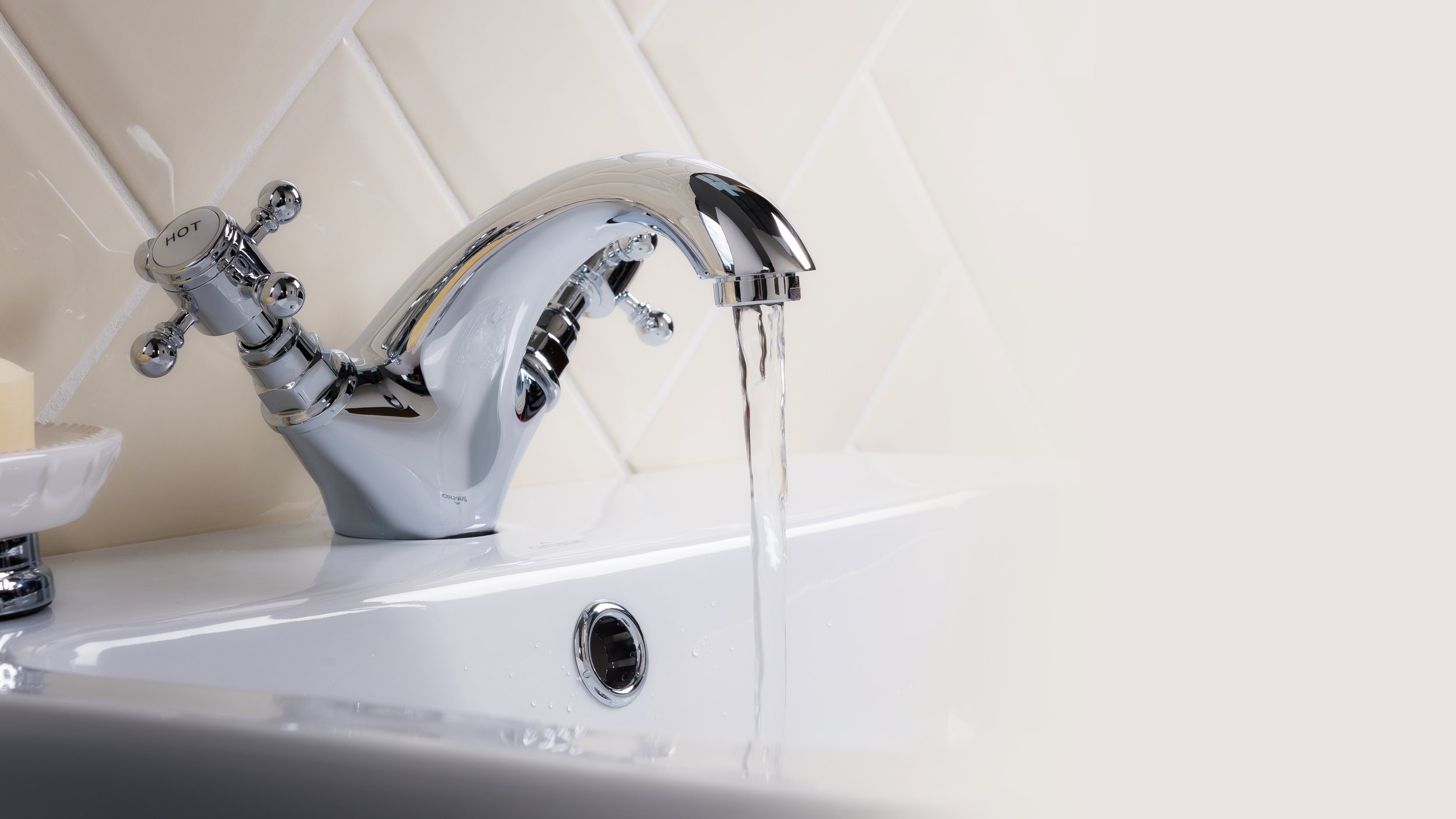 closeup-shot-water-flowing-from-basin-mixer-tap-bathroom.jpg