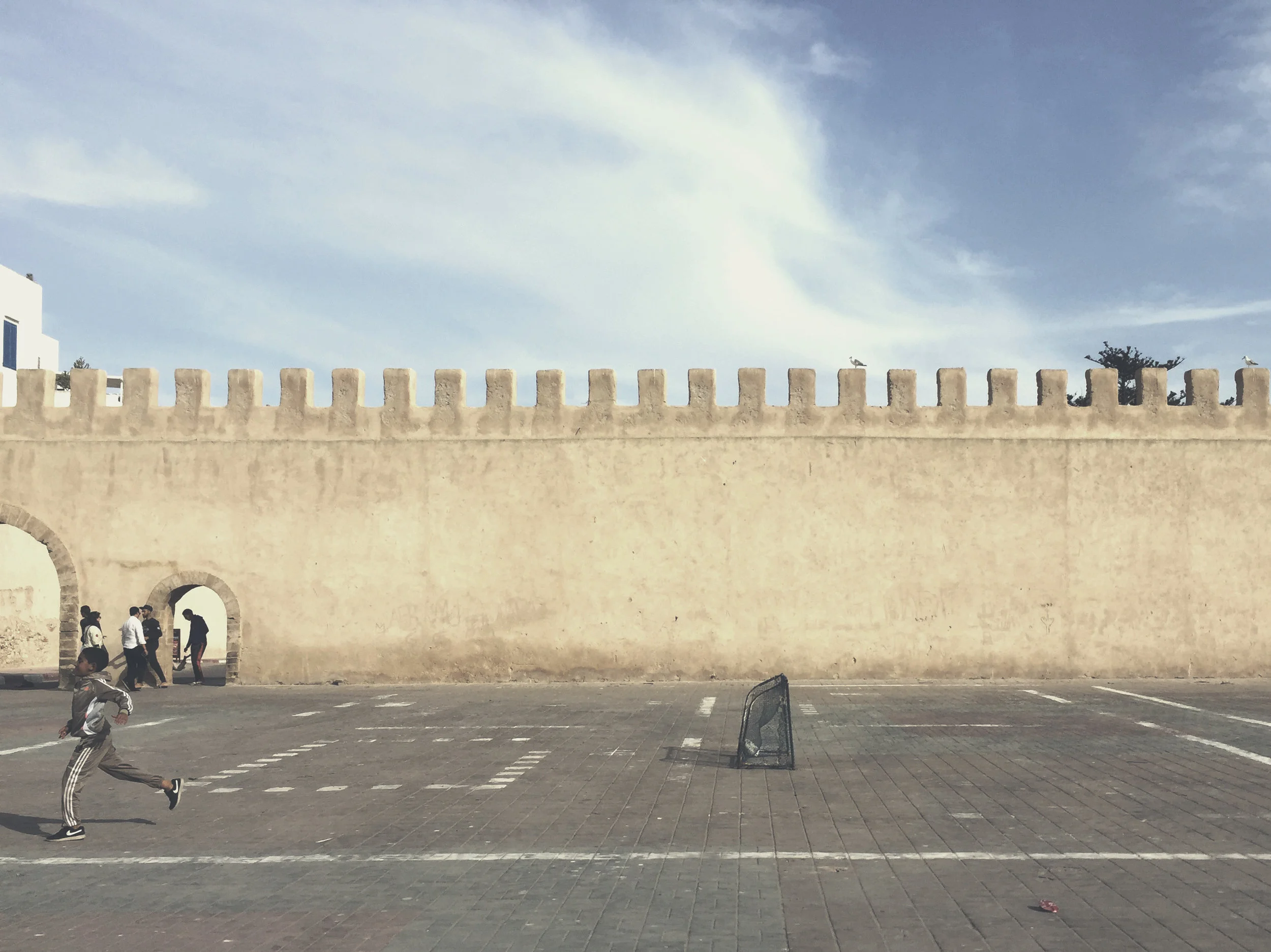 Kids playing football on the square in Essaouira