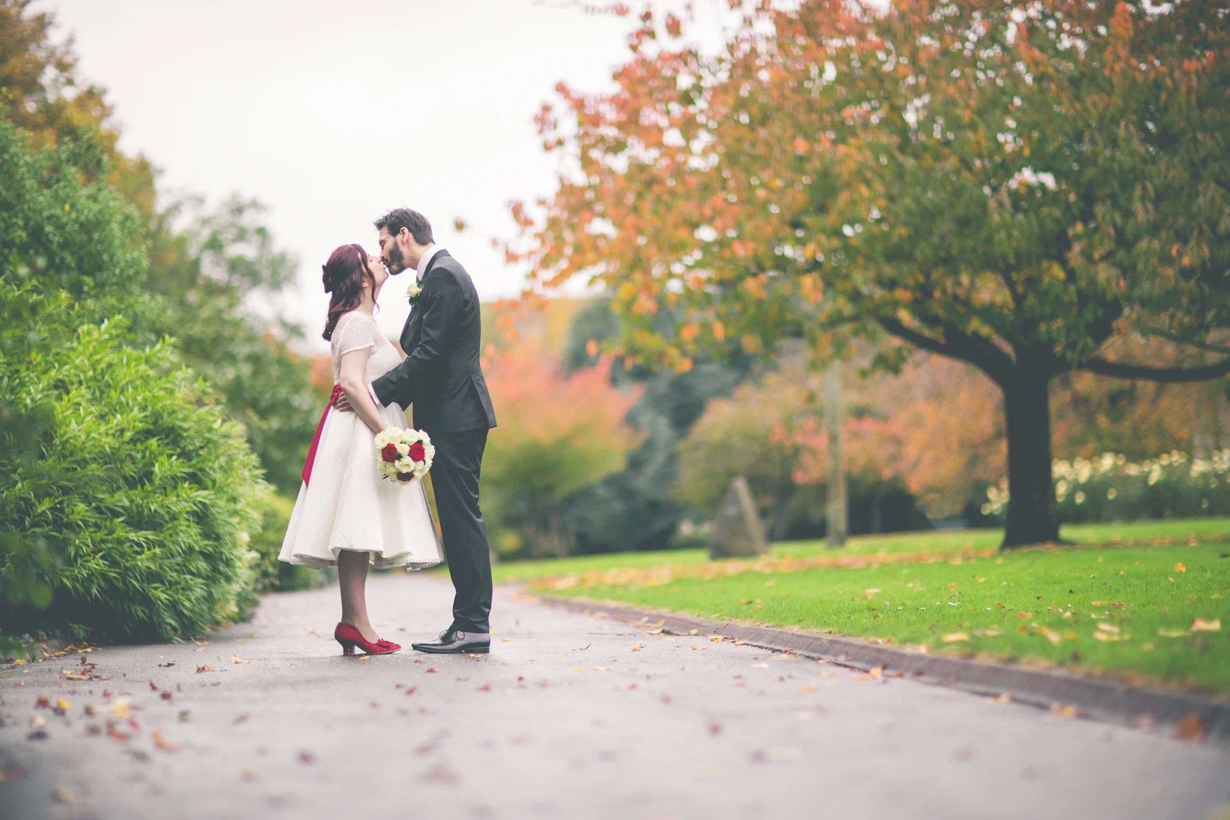I never considered myself a 'typical' bride, so starting my search for the perfect dress was daunting to say the least! Part of me was dreading it, fearing I'd be forced into a dress that just wasn't me. Luckily, my search didn't go on too long, and only took me as far as Penarth, to Rachel's beautiful boutique. Rachel understood straight away that I didn't want a traditional dress. She found several dresses for me to try, from vintage gowns to handmade creations, and it was one of the latter - just the second dress that I tried on - that ended up being mine; "Lil is the dress for me" I told Rachel, and I think she was just as excited as I was to hear those words! Over the next few months I went for a number of fittings. Adjustments were made to ensure the dress was just right for me, and Rachel came up with some wonderful accessories - a petticoat, a sash and a pom pom for my hair - to match the ruby red shoes I'd chosen. She made the whole experience of choosing the right dress, and creating the perfect wedding outfit, entirely stress-free and fun. Thanks Rachel! Photo By: Maxine Howells Photography