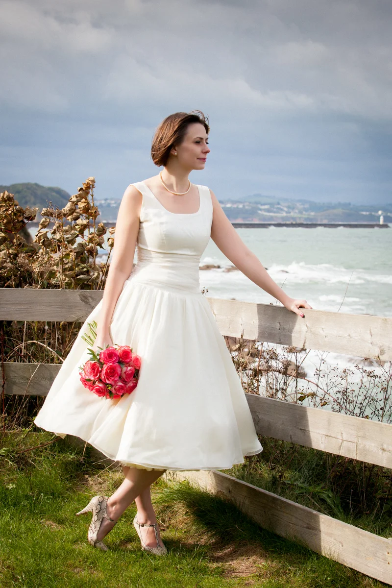 Rach, you don’t know this but we met on a dreary Tuesday lunchtime at my desk back in April this year, my mum was moaning to me via text message about how we had not done anything “wedding-related” since the engagement at Xmas, but lo and behold to her I was planning a wedding-dress-shopping-Easter-bank-holiday visit home, the problems began when I didn’t know where to start. So I googled “Vintage Wedding Penarth” and there you were. I had a vague idea of the type of dress I had in mind; I wanted a classic simple stylish dress and so on that Easter Weekend I took the plunge and visited the first and only Wedding Dress shop, and there was Penny. With your help and the fabulous skills of the lovely Annie, we gave old Penny a new lease of life and brought her into the 21st Century. Everyone loved the dress, thank you so much ladies from the very bottom of my heart. Photo By: Gary Stevens Photography