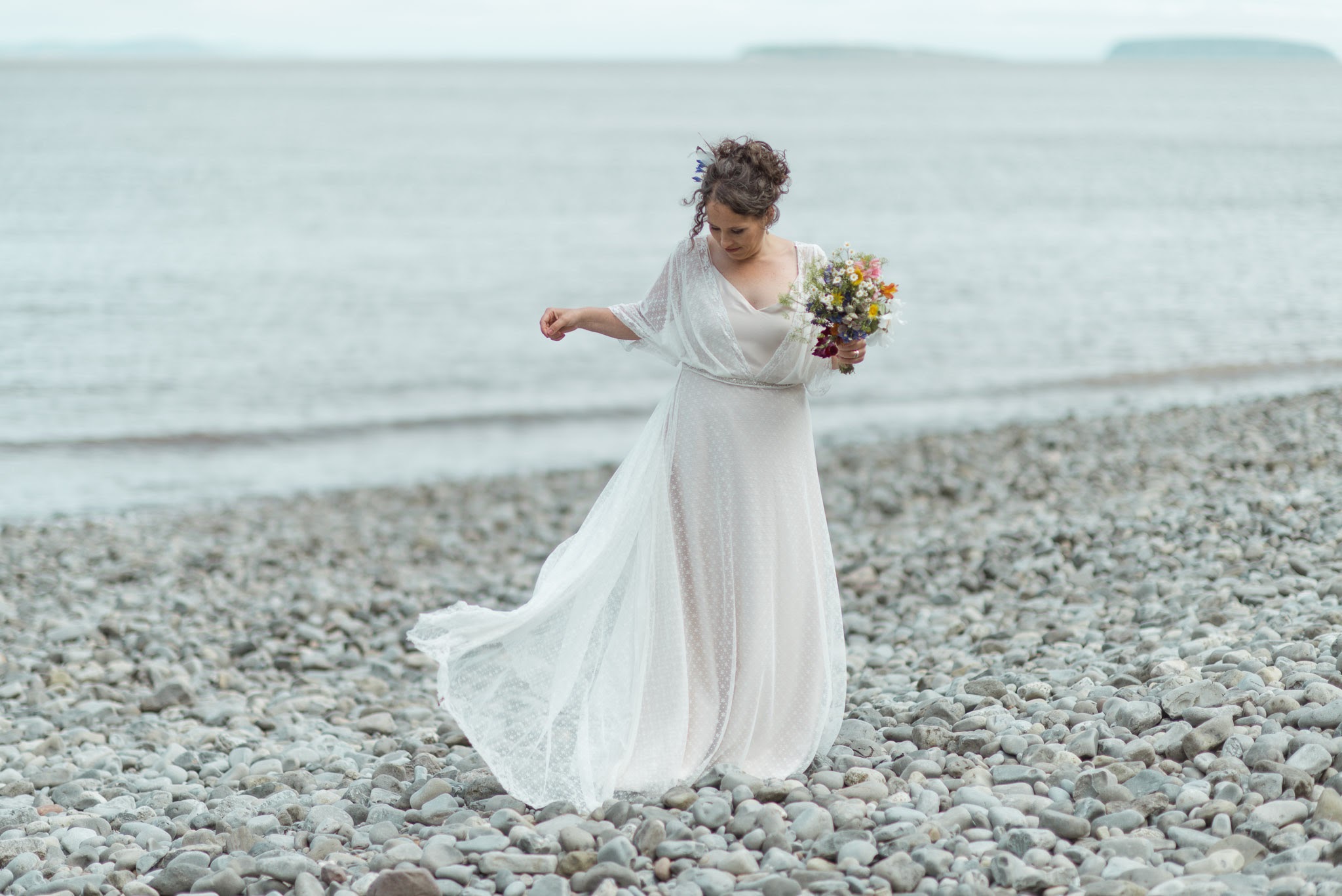 "From the beginning I knew I was going to enjoy Rachel's Bridal Boutique, the sumptuous interior is delightful, all the beautiful dresses, and photos of Boutique Brides proudly on display. Rachel's service is extraordinary, she made me feel unique and helped me to relish in the experience of being a Bride, even offering top tips for the day, to show off my incredible handmade dress to it's best! My dress, crafted by Amy Mair is a work of pure love. When Amy brought it for the first fitting, there were adjustments I wanted to make to the design, Amy and Rachel embraced my desires, and the dress couldn't be more perfect. There is something truly wonderful about having a dress made for you, I looked forward to each visit, and enjoyed seeing the dress take shape. It's the little details that made all the difference, being shown how to step into the dress, feeling a dreamlike quality as I saw myself for the first time, the hand-written note on the postcard, the smell of the boutique, it was all so good! Rachel offers such a warm, open hearted, and individualised service. I won't hesitate to recommend Rachel to others." Photo By: Severn Tides