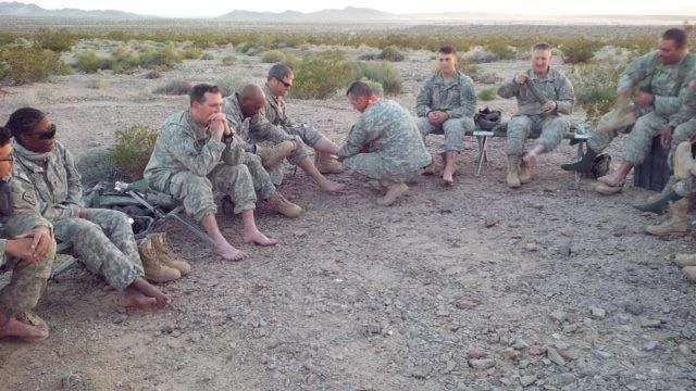 A military chaplain washes the feet of members of the U.S. military. On Maundy Thursday, we remember Jesus’ commandment to love one another. As Jesus washed the feet of his disciples, we are called to follow his example as we humbly care for one ano…