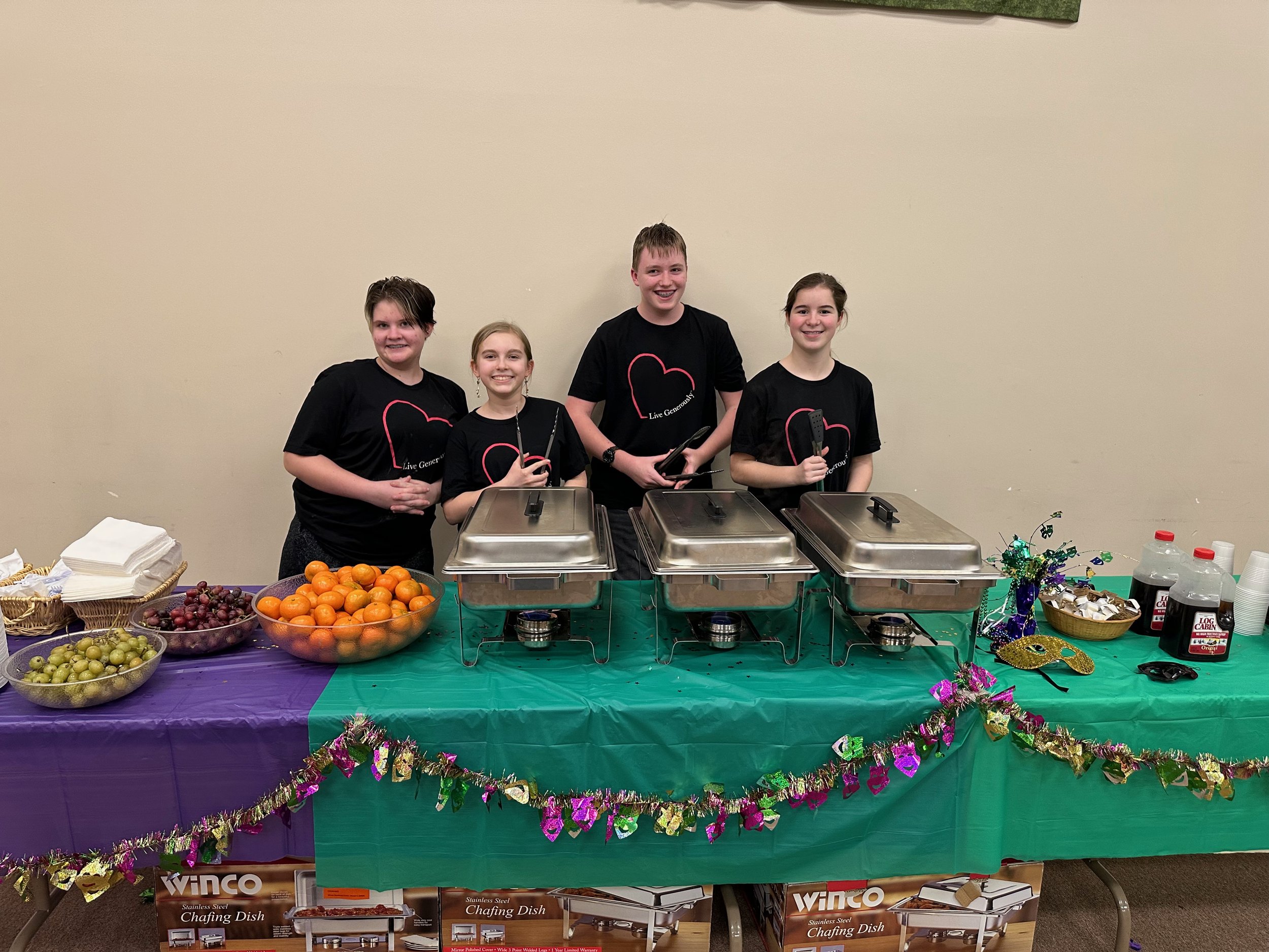 Serving Pancakes at the Mardi Gras Concert Spring 23