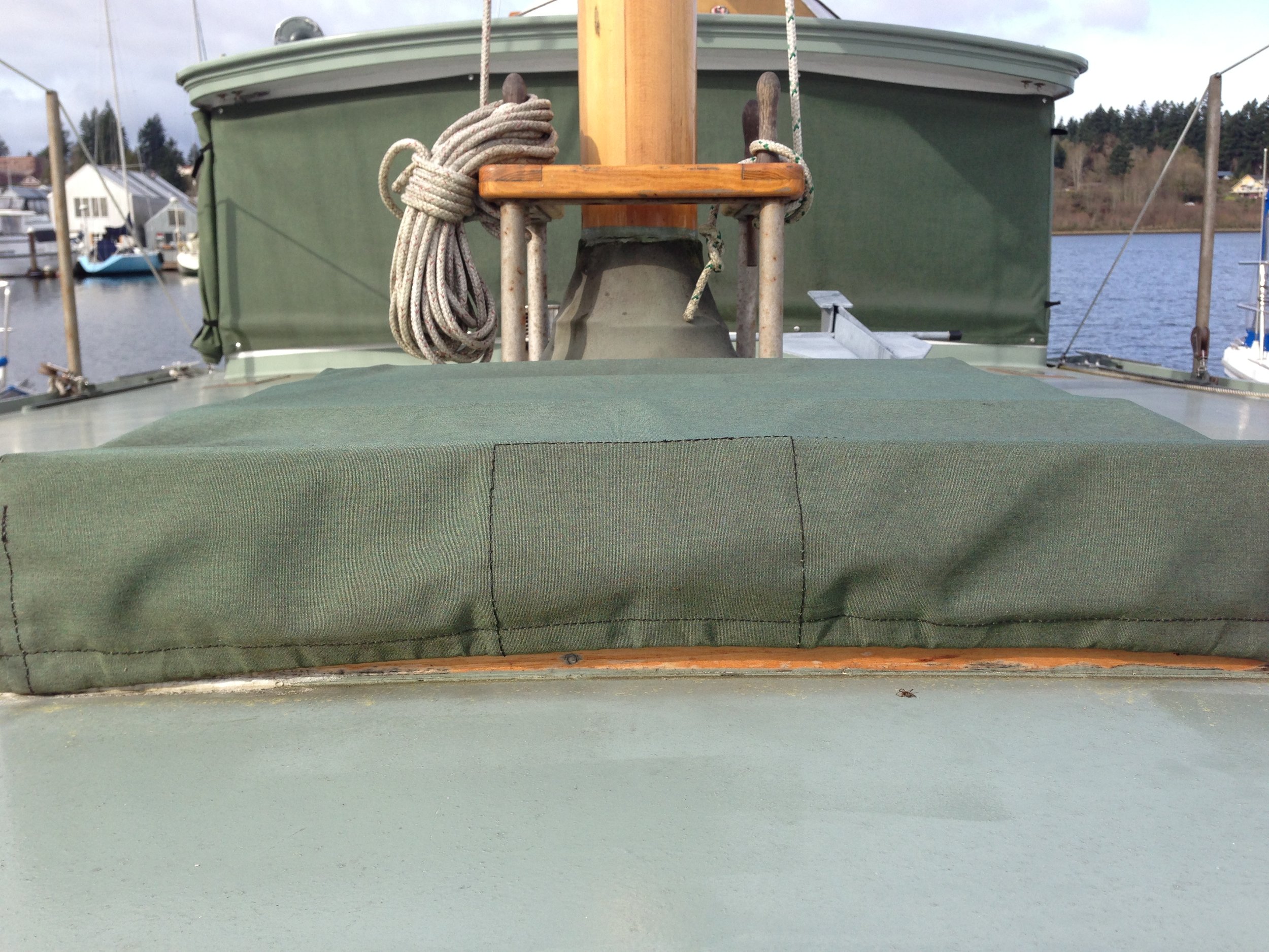 Sunbrella green canvas covers for hatch, windows, sails and stern