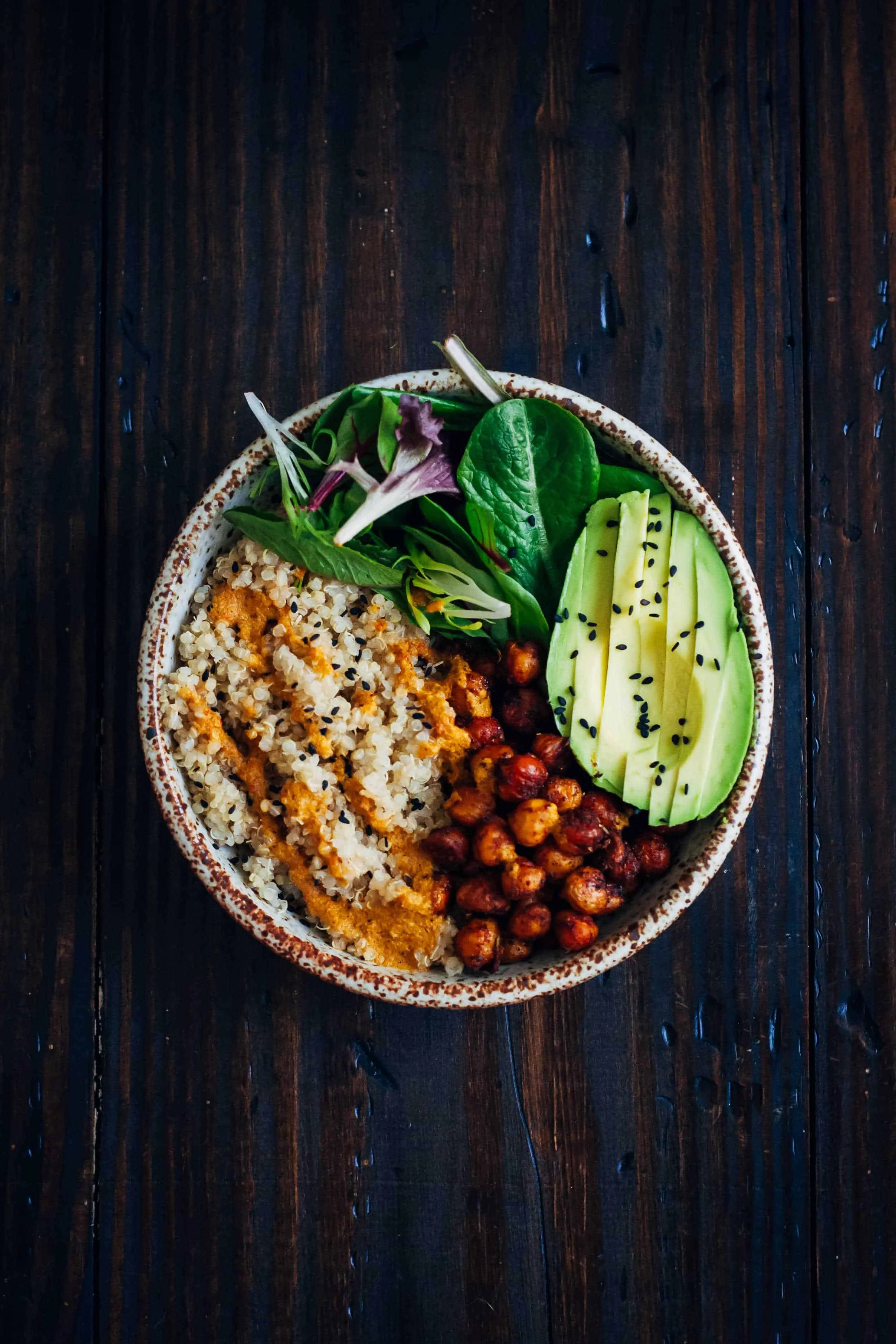 You can find a healthy bowl on menus across the country now, I love them! They are the perfect way to prepare your balanced meal with protein, fats and carbs. Try this amazing recipe at home. Post your pictures let me see. The Vegan Buddha Bowl This vegan buddha bowl has it all - fluffy quinoa, crispy spiced chickpeas, and mixed greens, topped with a mouthwatering red pepper sauce! Prep Time 15 minutes Cook Time 25 minutes Total Time 40 minutes Servings 2 Ingredients Quinoa 1 Cup Quinoa rinsed 2 Cups Water Chickpeas 1 1/2 Cups Cooked Chickpeas Drizzle Olive Oil or other neutral oil 1/2 Tsp Salt 1/2 Tsp Smoked Paprika 1 Tsp Chili Powder 1/8 Tsp Turmeric 1/2 Tsp Oregano Red Pepper Sauce 1 Red Bell Pepper ribs and seeds removed 2 Tbs Olive Oil or other neutral oil Juice from 1/2 Lemon or more to taste 1/2 Tsp Pepper 1/2 Tsp Salt 1/2 Tsp Paprika 1/4 Cup Fresh Cilantro Everything Else Mixed Greens An Avocado Sesame Seeds for Garnish Instructions Start by cooking the quinoa. Bring 2 cups water to a boil, then add quinoa. Simmer for about 15 minutes until all water is absorbed. When done, remove from heat and keep covered for about 10 minutes so quinoa can absorb any excess water. Preheat oven to 425. In a bowl, toss chickpeas, oil, and spices until chickpeas are evenly coated. On a baking sheet lined with parchment paper, bake chickpeas for 15-20 minutes, or until desired doneness is reached. When done, remove from oven and let cool. To make red pepper dressing, add all dressing ingredients to a blender (not a food processor) and blend on high until smooth. Taste, and adjust seasonings to your preference. Finally, assemble the Buddha bowls. In two bowls, add quinoa, mixed greens, avocado, and chickpeas. Drizzle everything with red pepper sauce, and sprinkle with sesame seeds.