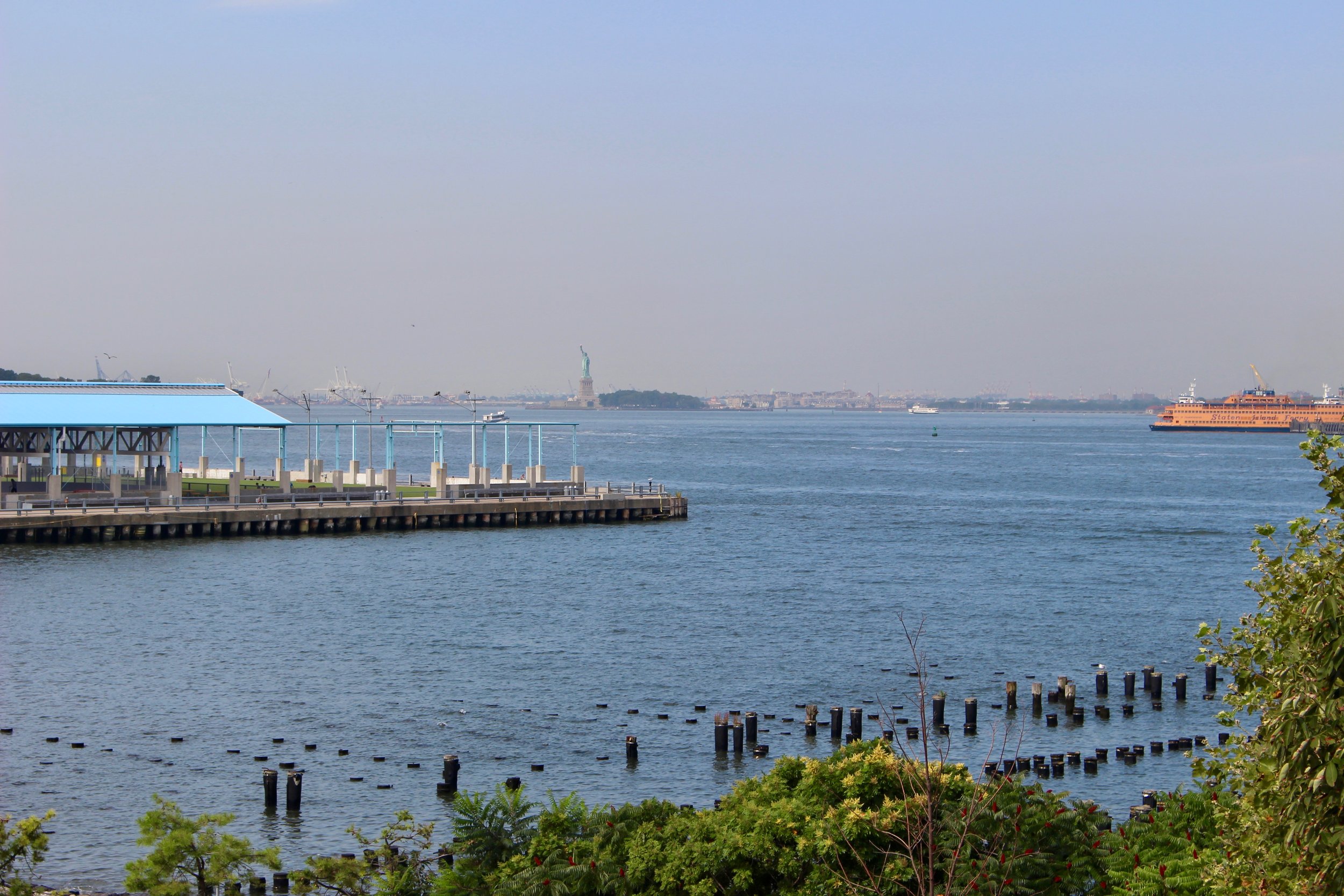  Reaching the end of the footbridge and stepping out onto the path, here is the view.&nbsp; Note the Staten Island Ferry making its way into the Harbor and the Statue of Liberty.&nbsp;&nbsp;It is always breath taking, no matter how many times you app
