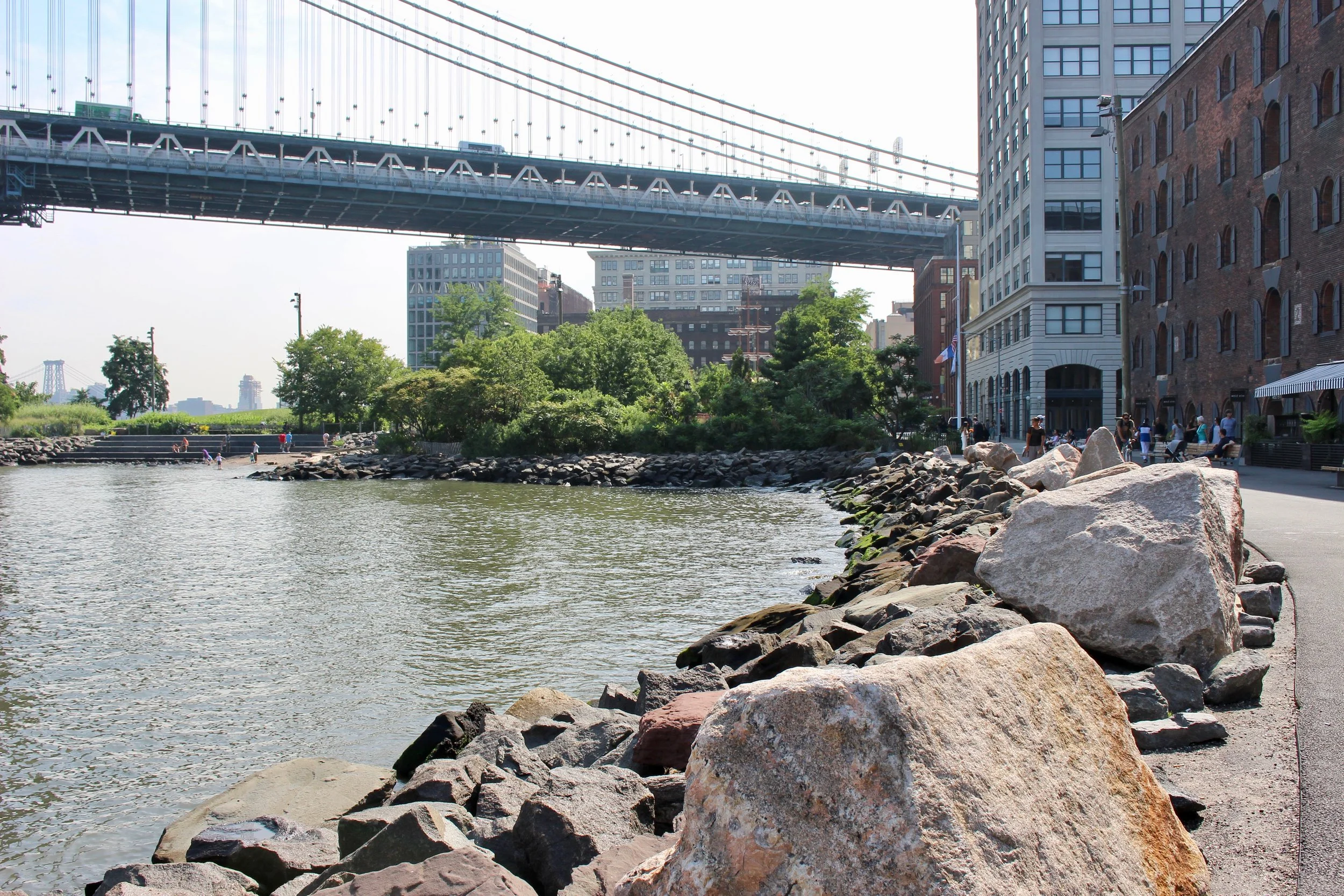 One can walk through the "plaza" between St. Ann's Warehouse and the Empire Stores or through the Empire Stores building to continue walking along the East River through Brooklyn Bridge Park. The east side of these buildings are river front. See the patio of Cecconi's on the right. The well-known landmark, the Clock Tower building is just beyond the Empire Stores on the other Side of Main Street, and the Manhattan Bridge is beyond that.