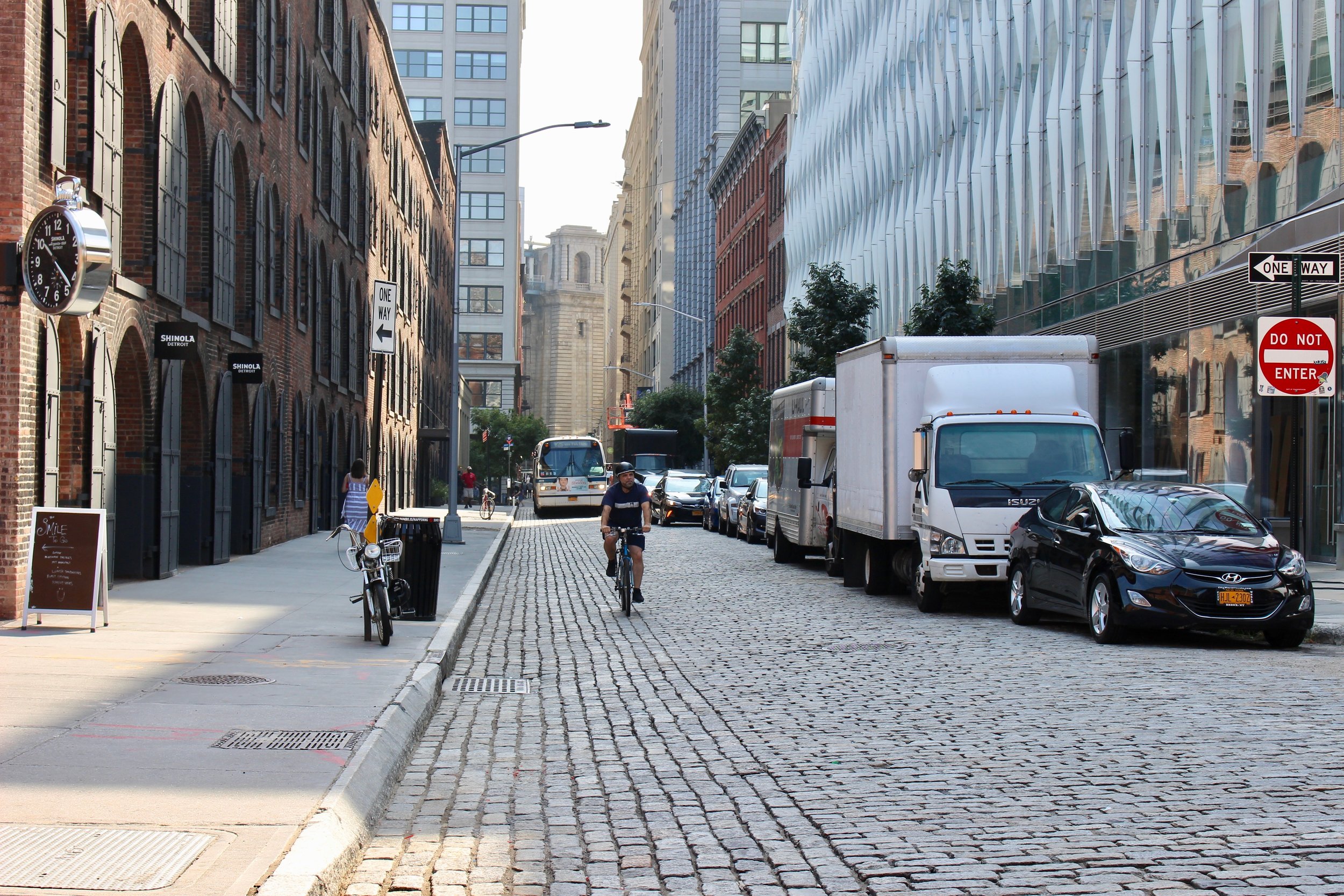  Looking north on Water Street.&nbsp; Past Main Street you can see the Manhattan Bridge stanchion. Note the cobble stone street, which is the case throughout DUMBO.&nbsp; Bicyclists, buses, cars, and pedestrians happily go about their business on the