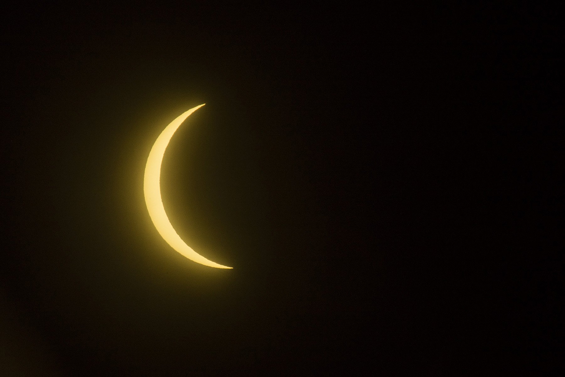   A photo of the eclipse at its peak on Long Island, 3:26 p.m. from Hauppauge. © Jim Lennon  