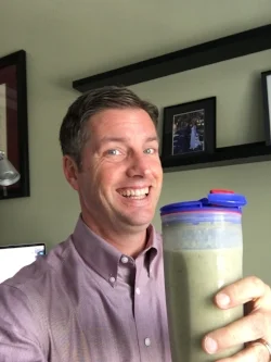 Enjoying a green smoothie at work.