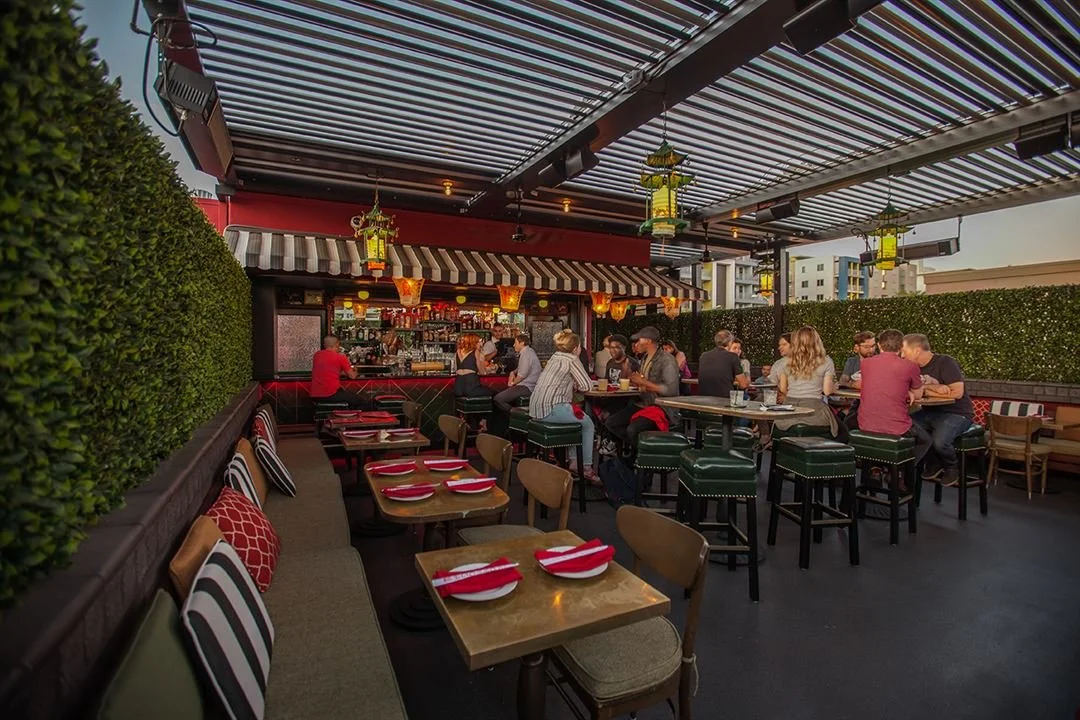 People eating lunch at the spacious, relaxing outdoor rooftop patio at The Formosa Cafe.
