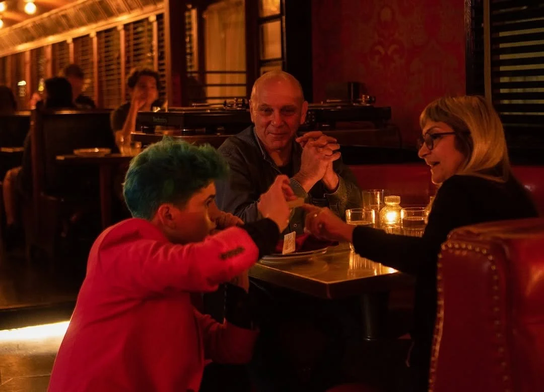 Family enjoying a relaxed meal together inside The Formosa Cafe with cozy seating and warm lighting