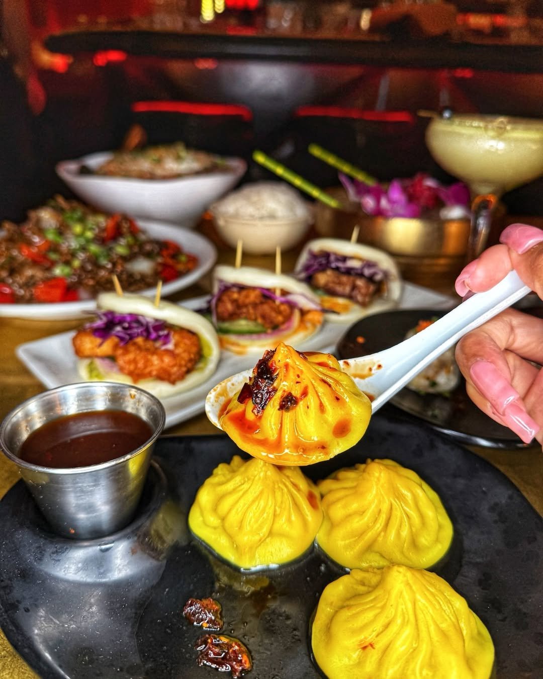 Close-up of dumplings with chili oil, bao buns, and Chinese-American dishes served at The Formosa Cafe