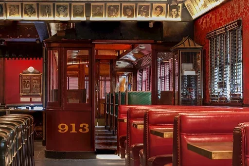 Vintage Pacific trolley car 913 seating area alongside red leather booths at The Formosa Cafe in West Hollywood.