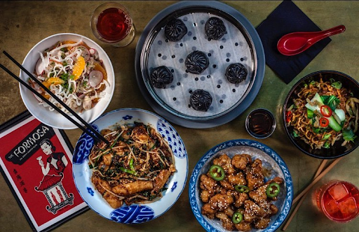 Chinese-American dining spread featuring black soup dumplings, small plates, and shared dishes at The Formosa Cafe.