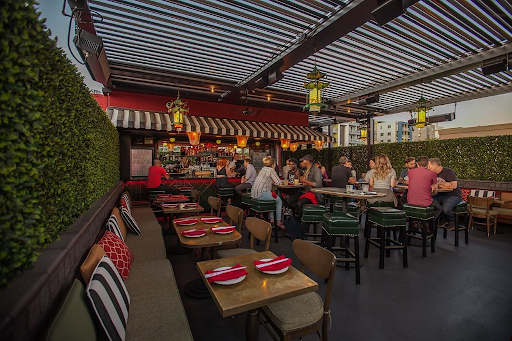 Guests dining and socializing on The Formosa Cafe’s outdoor rooftop patio in West Hollywood during a warm evening.