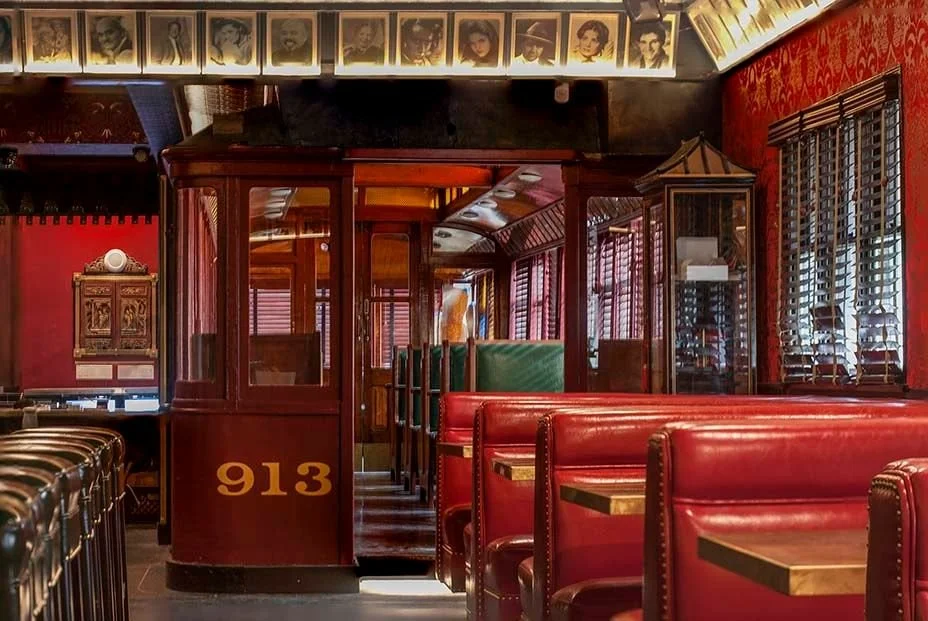 Legendary 913 Pacific Electric Trolley car at the Formosa, featuring plush red booths and vintage celebrity photos.