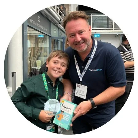Circular image of James Green of Scanning Pens and a young winner being presented with a C-Pen Reader 2 reading pen