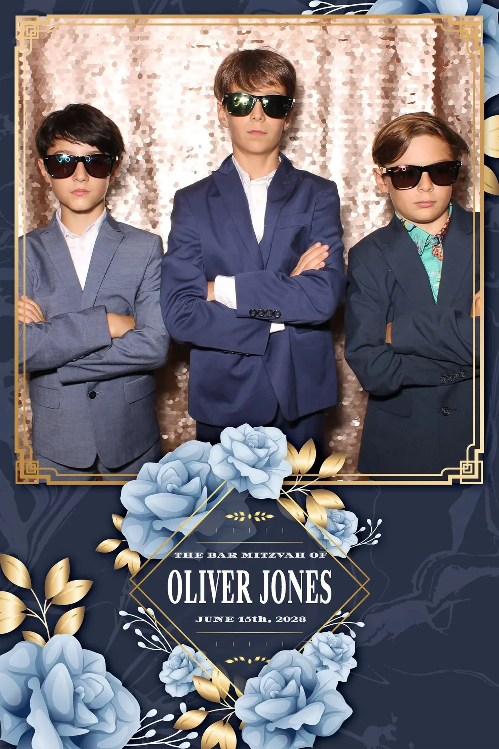 Three boys in suits and sunglasses posing with arms crossed in front of a sequin backdrop, with a decorative frame featuring flowers and gold accents, and text for Oliver Jones's bar mitzvah on June 15th, 2028.