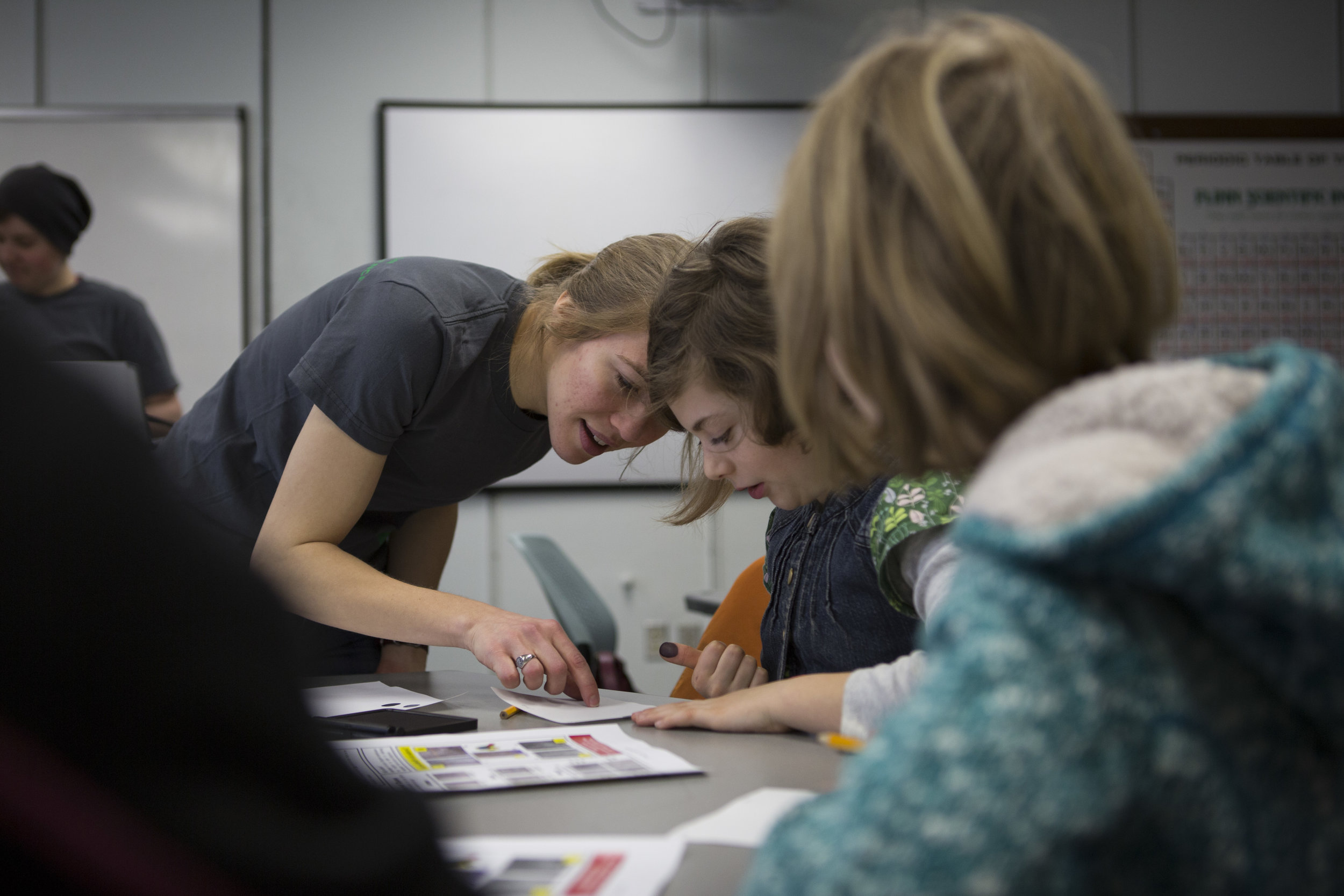  Part of Dana Reuter's duties with the UO Women in Graduate Science is to plan and lead outreach events to encourage young girls to show interest in science. Reuter shows a group of fourth graders how to analyze handwriting at a girls forensic scienc