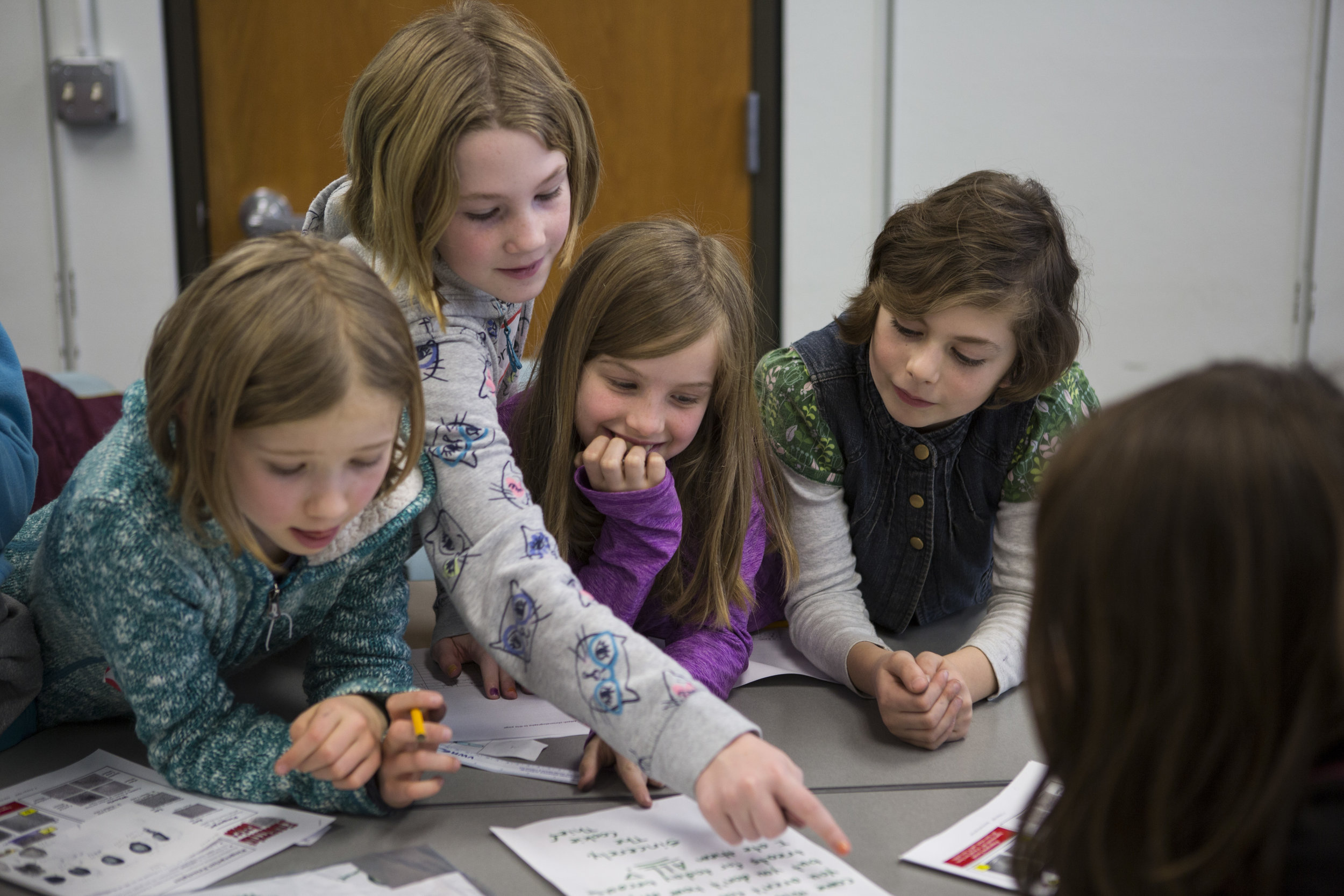  From left, Kora Purdy, Brianna Jecklin, Wren Wooten and Emma DeCicco analyze handwriting as part of a forensic science workshop held in conjunction with the UO Women in Graduate Science and the Eugene Science Center.  