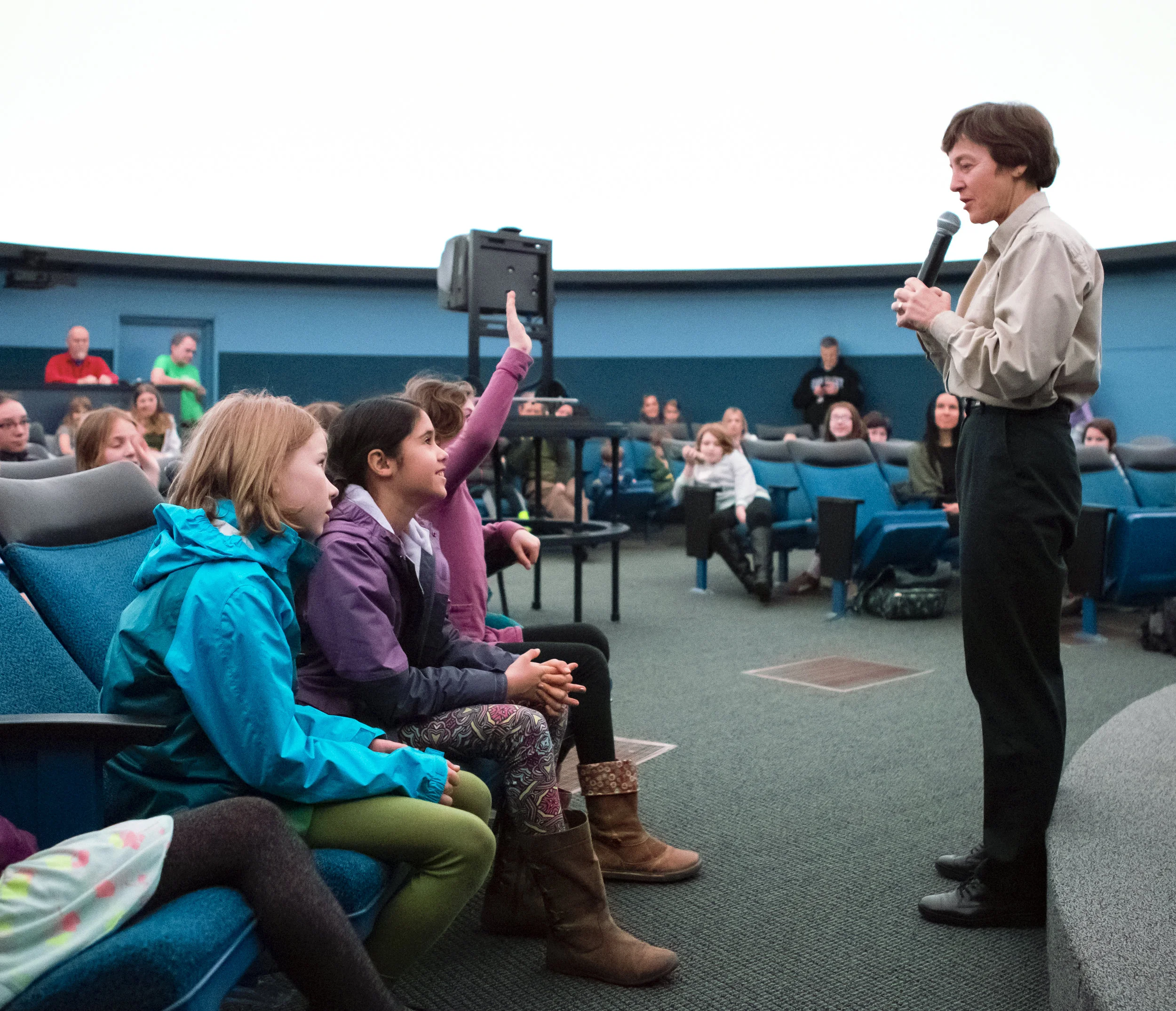 Astronaut Wendy Lawrence answers questions from the Girls' Science Adventure workshop participants in the Eugene Science Center planetarium.