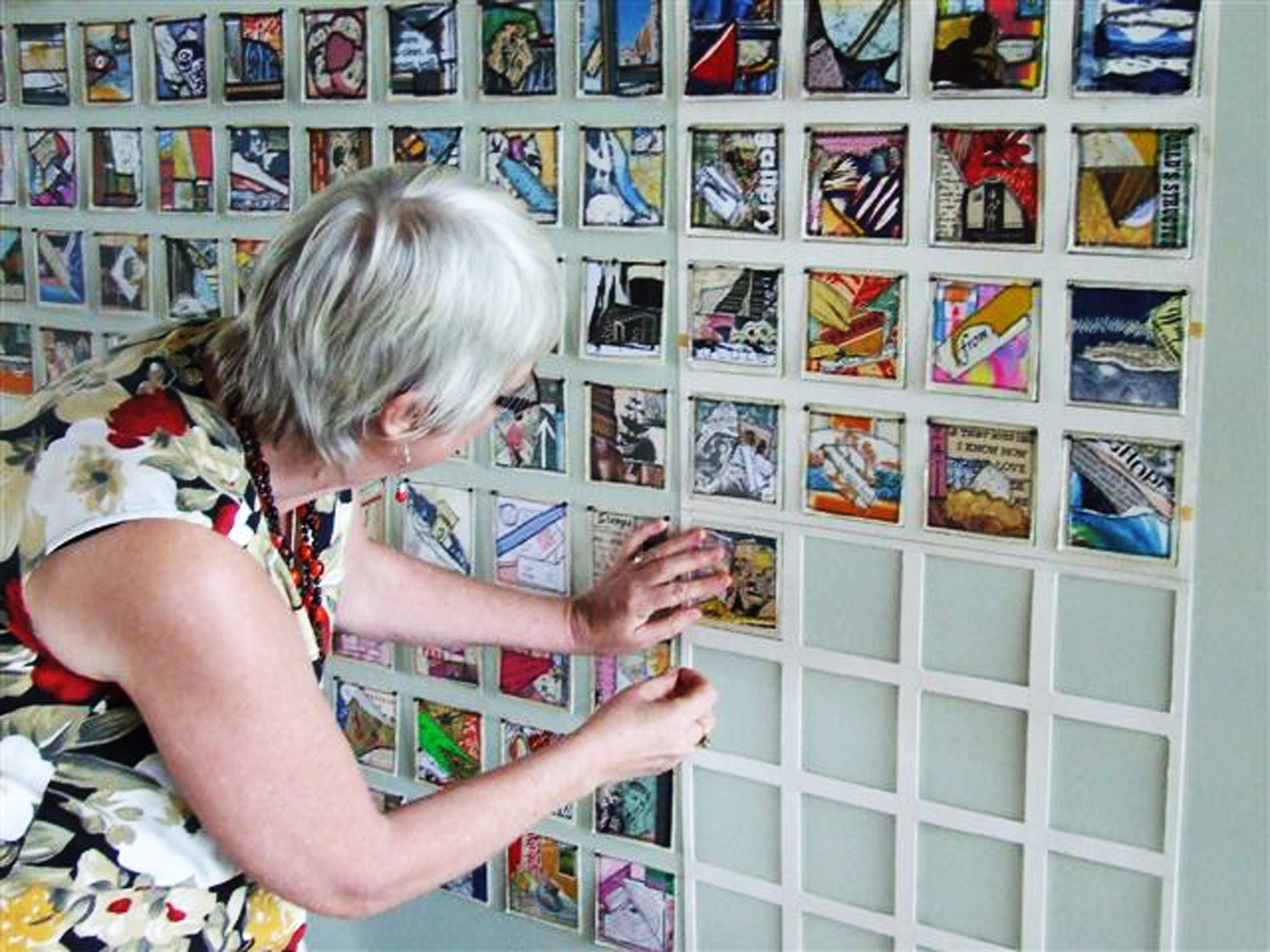  Each machine stitched paper collage was installed in a grid on the gallery foyer wall. 