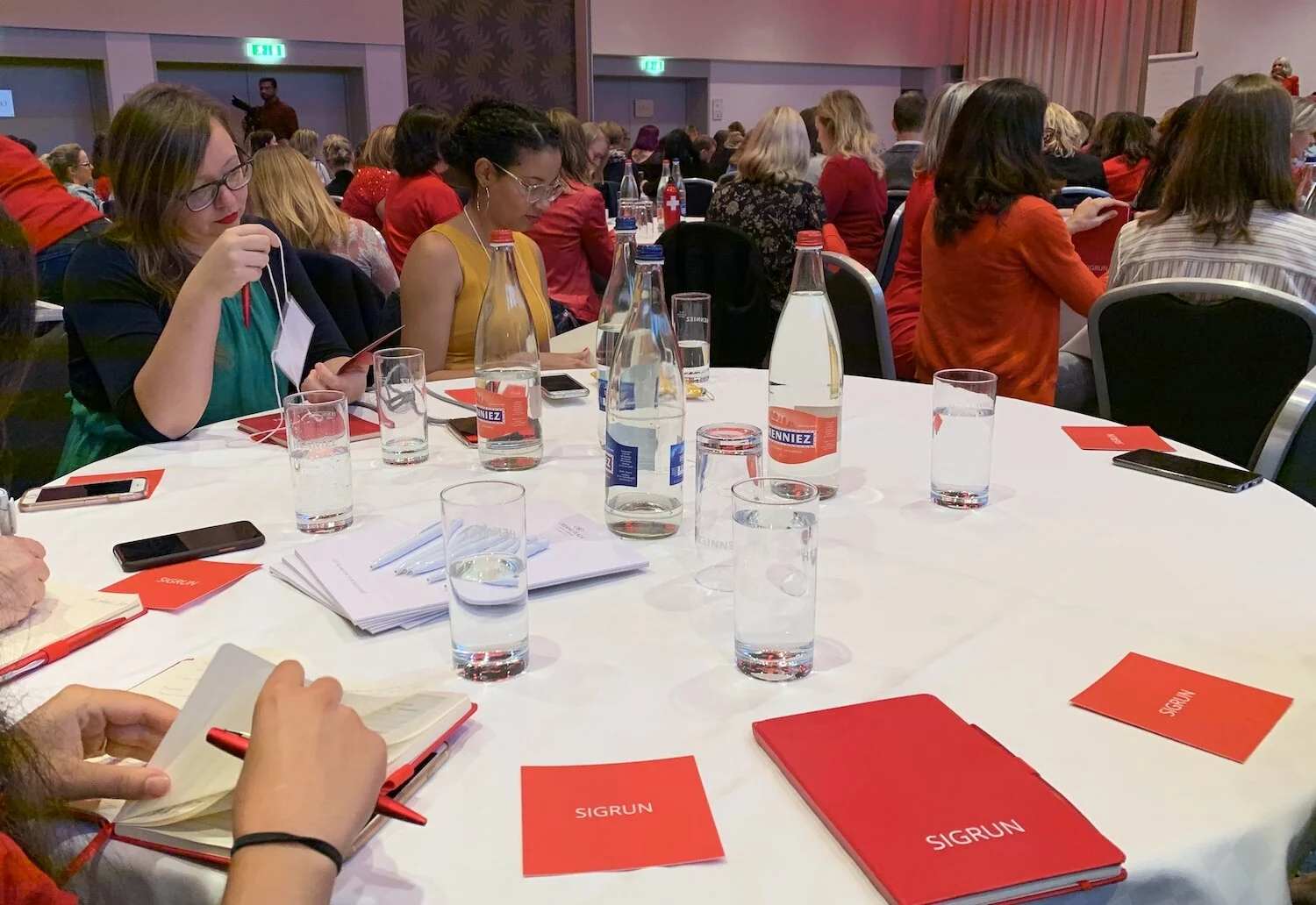 Taking notes at the Crowne Plaza Hotel conference tables for Sigrun Live.