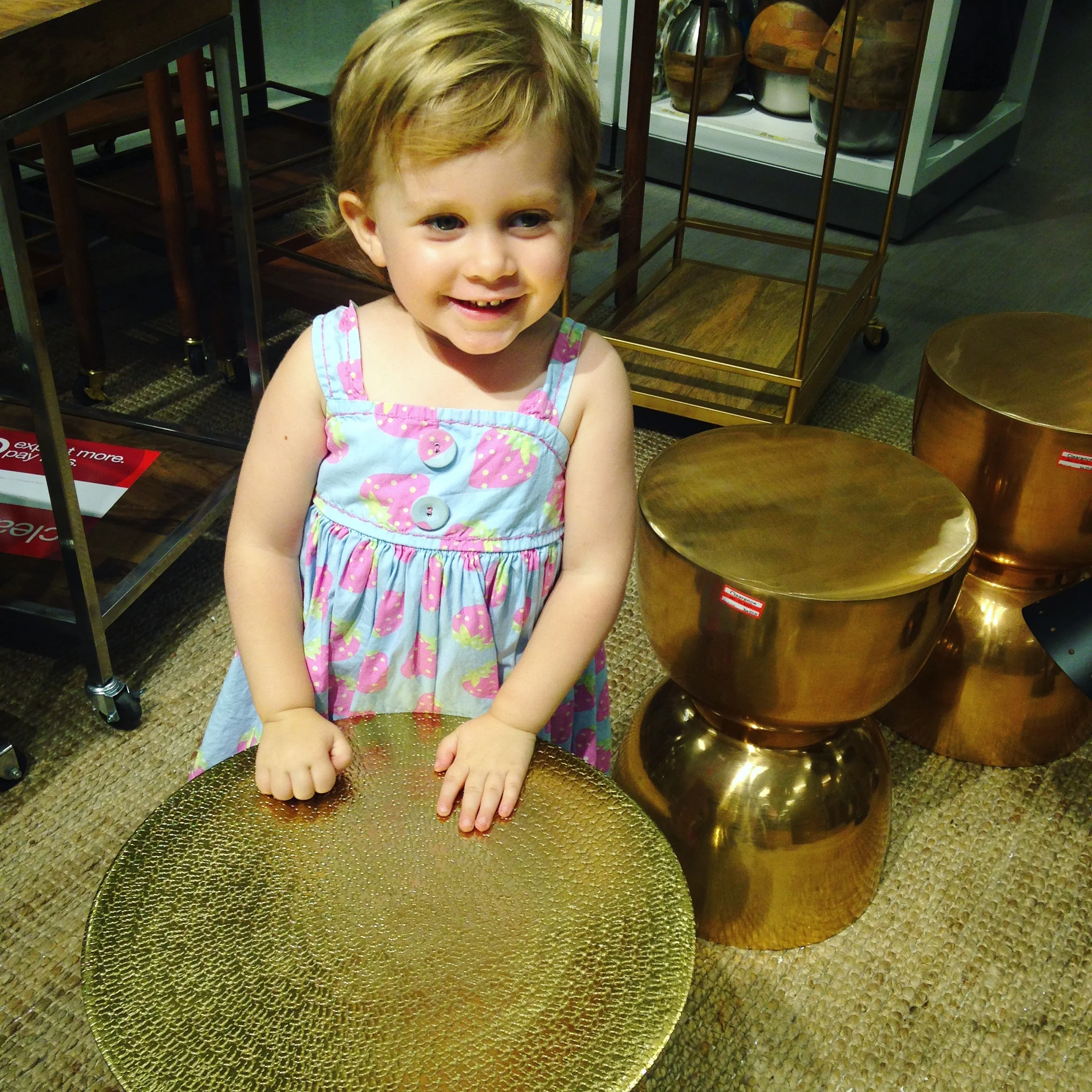 Penny playing impromptu side-table "drums" on clearance at Target, her favorite store in the world.