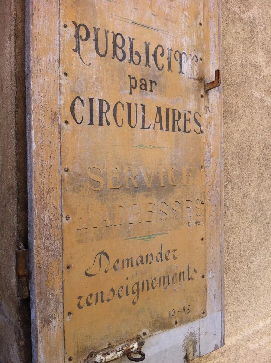 In addition to their many purposes, shutters were also used for advertising. This set can be found in the beautiful town of Beaune in Burgundy. They have been left to age gracefully.