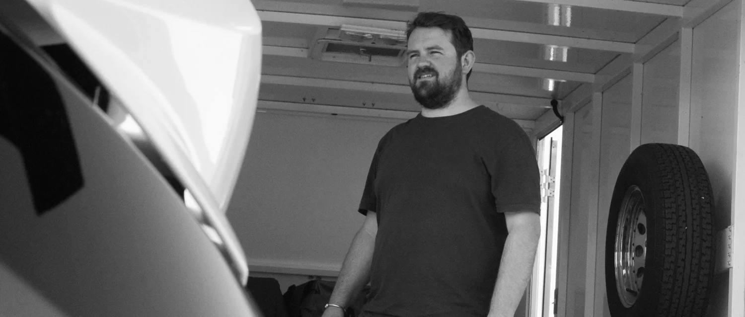 On location, sheltering from the heat in the motorbike trailer
