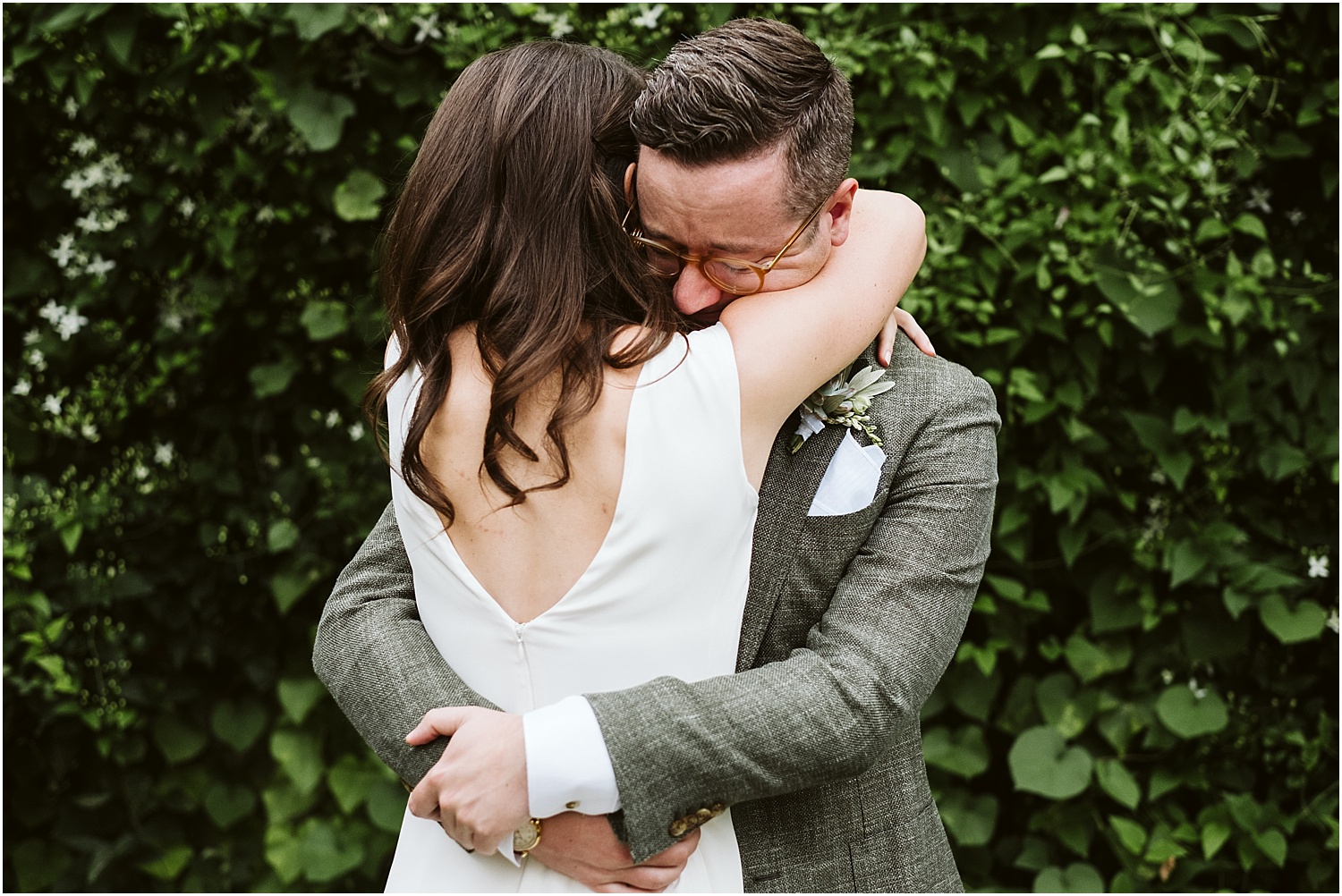 Groom hugs bride after seeing her for the first time on their wedding day at this Saddle and Cycle Club wedding by Michael and Kristin