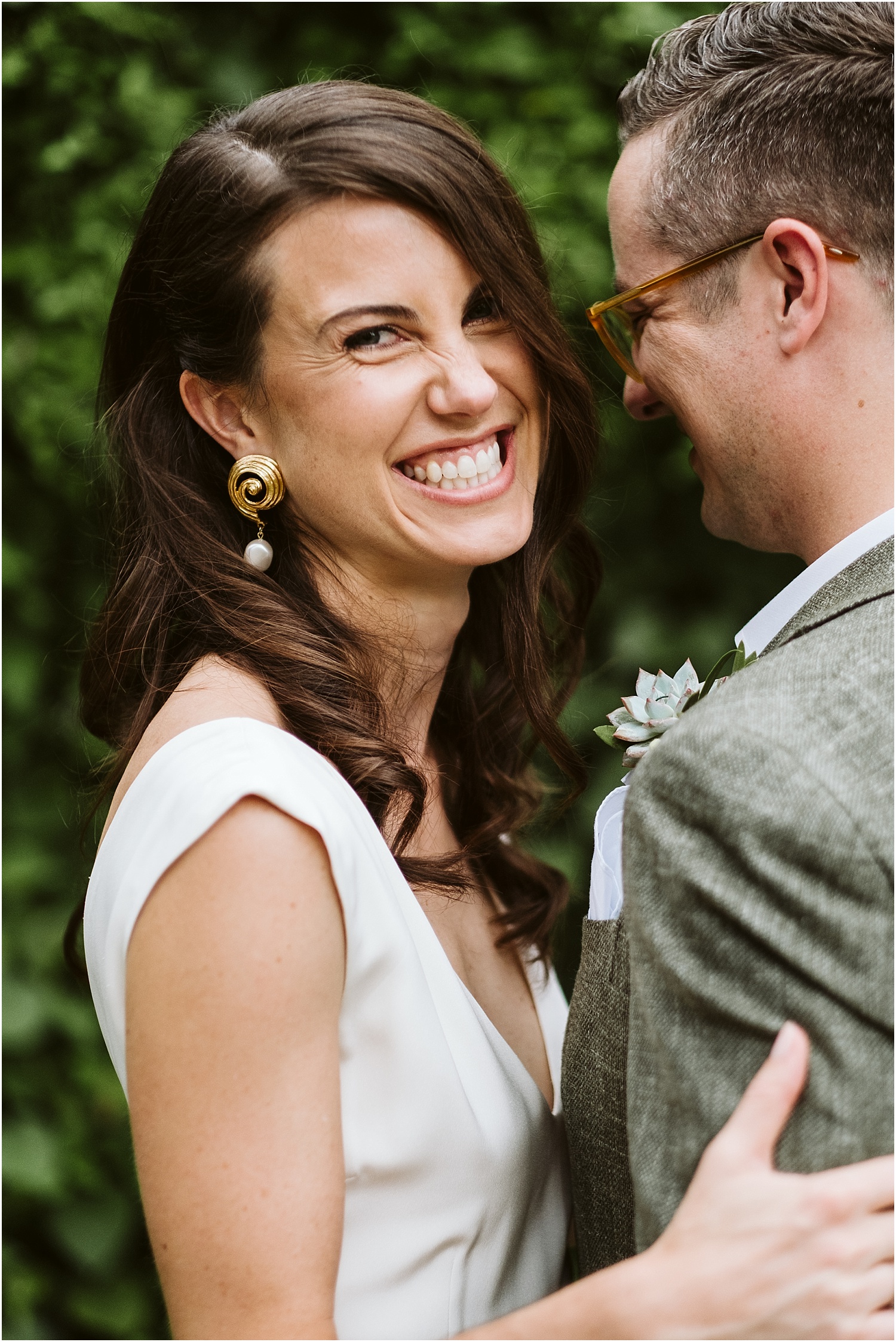Bride smiles at the camera at this Saddle and Cycle Club Wedding by Michael and Kristin