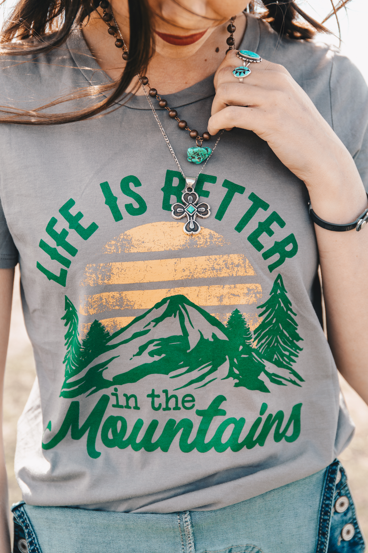Life is better in the Mountains and in this tee from Wild Rag Boutique. #wildragboutique #bohowestern #western #cowgirlstyle #cowgirl #fashion