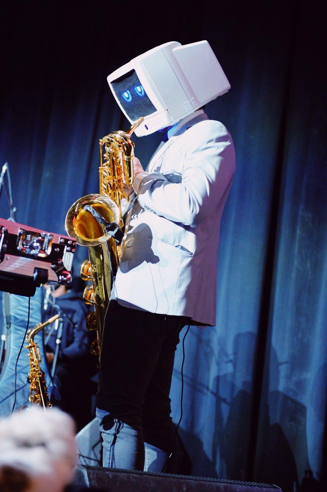 Robot DJ plays the saxophone